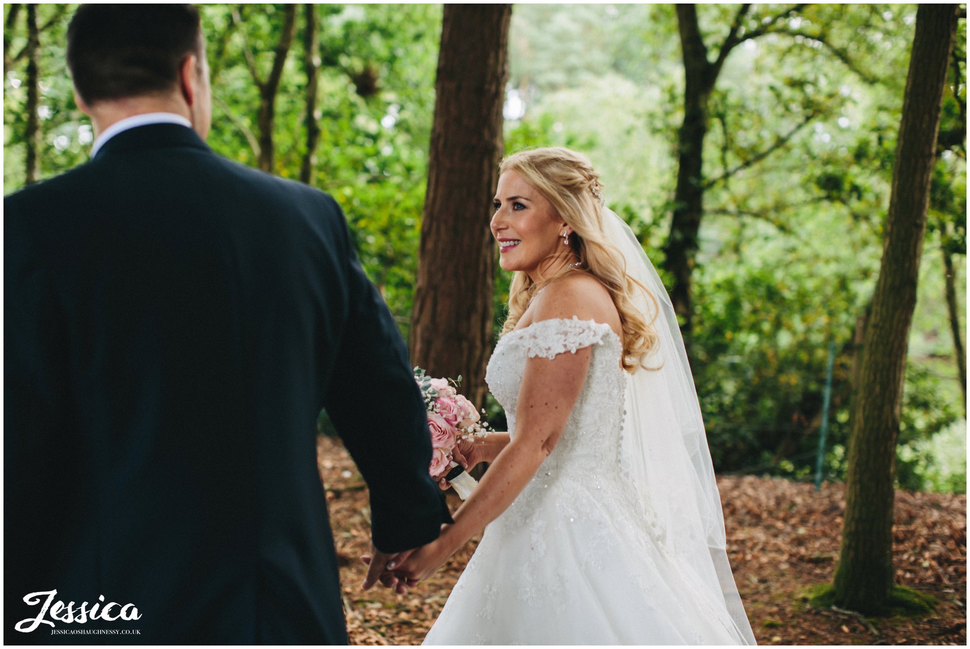 newly wed's holding hands in the forest - a cheshire wedding