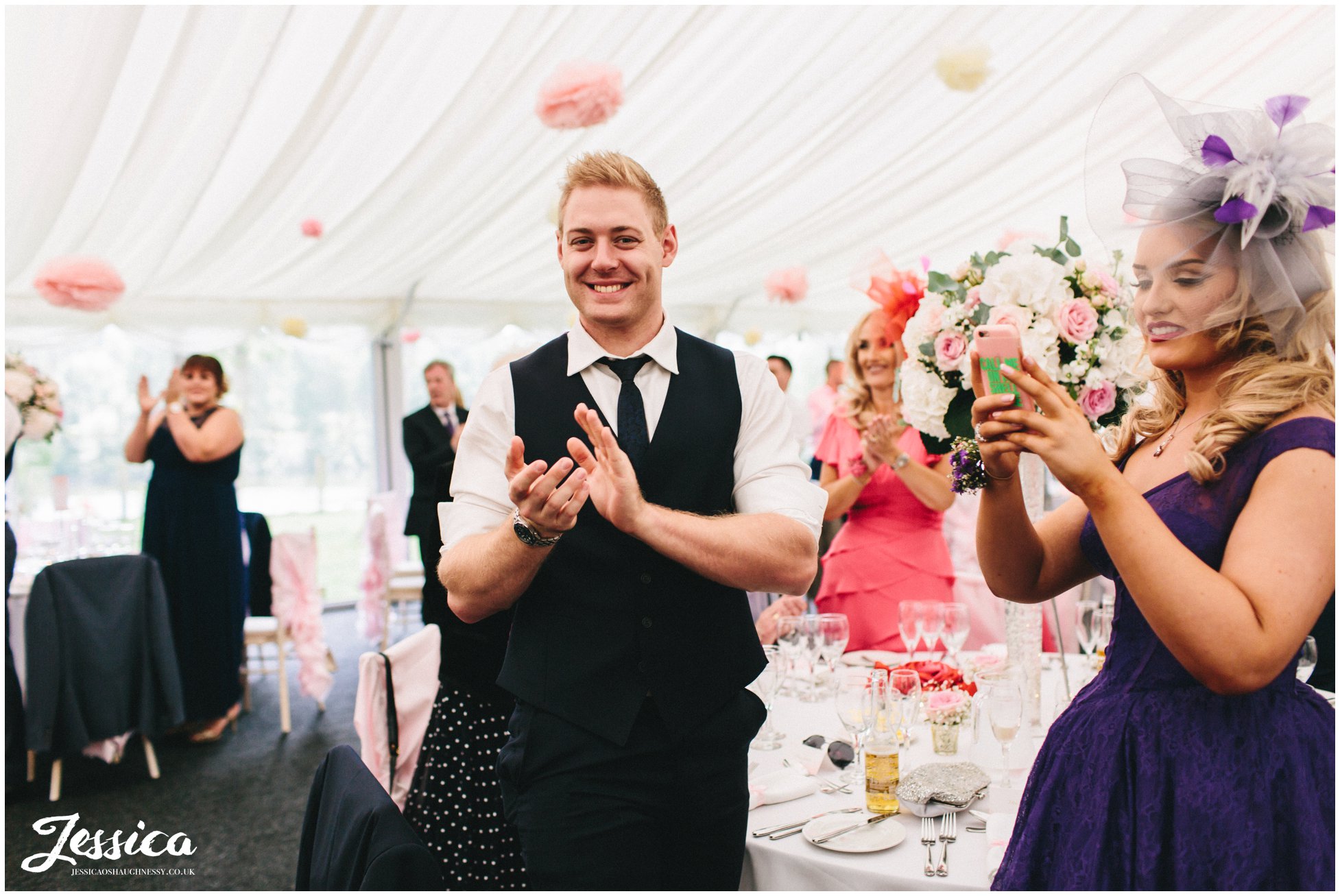 wedding guests clap as bride & groom enter