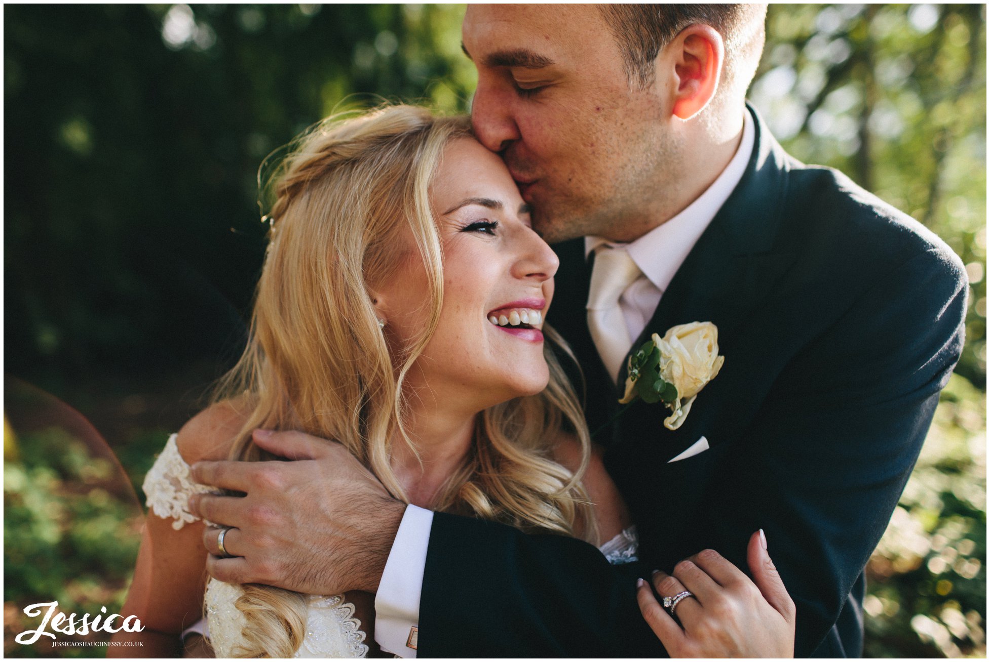 groom kisses brides forehead at nunsmere hall