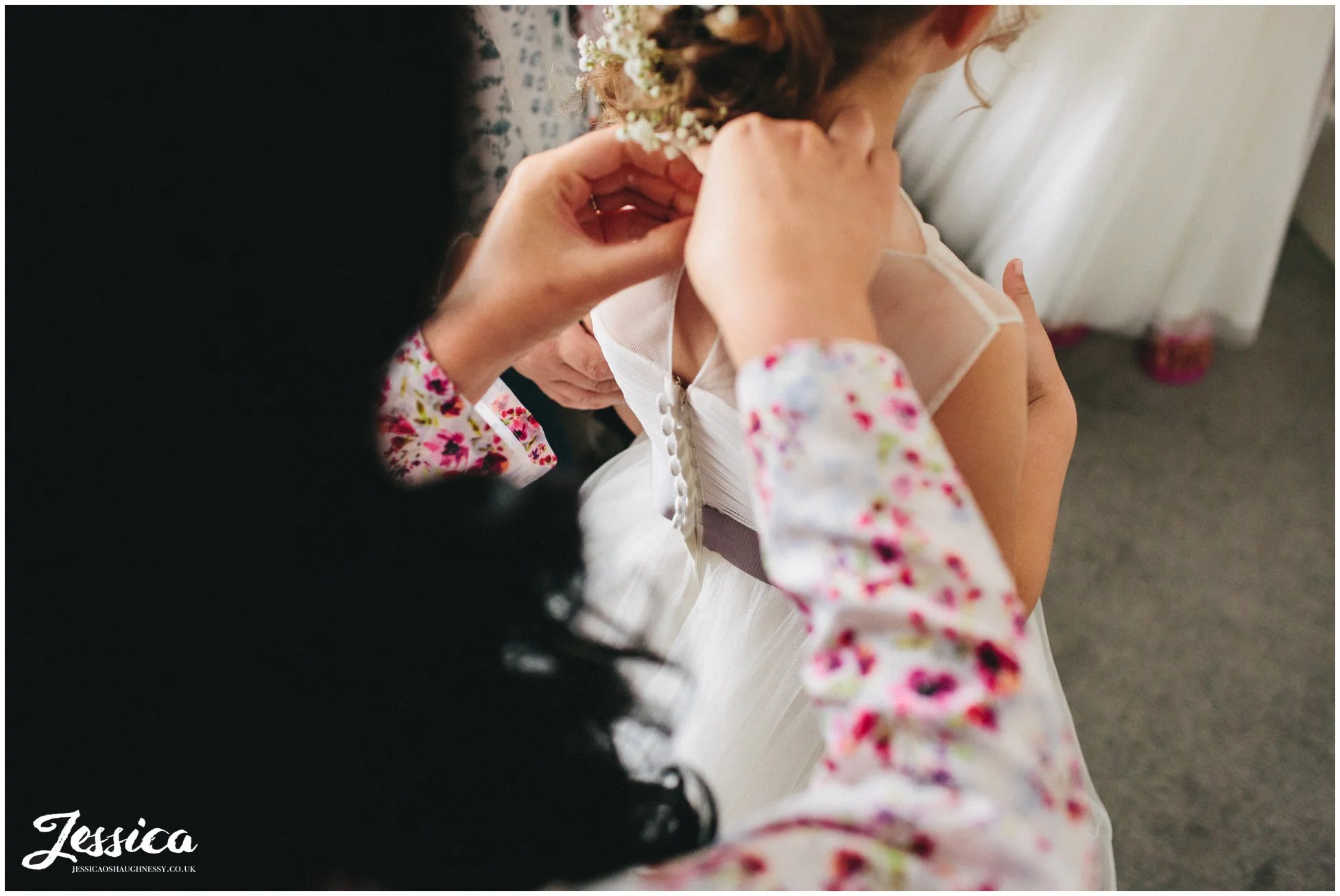 flower girl gets into her dress for the ness garden wedding