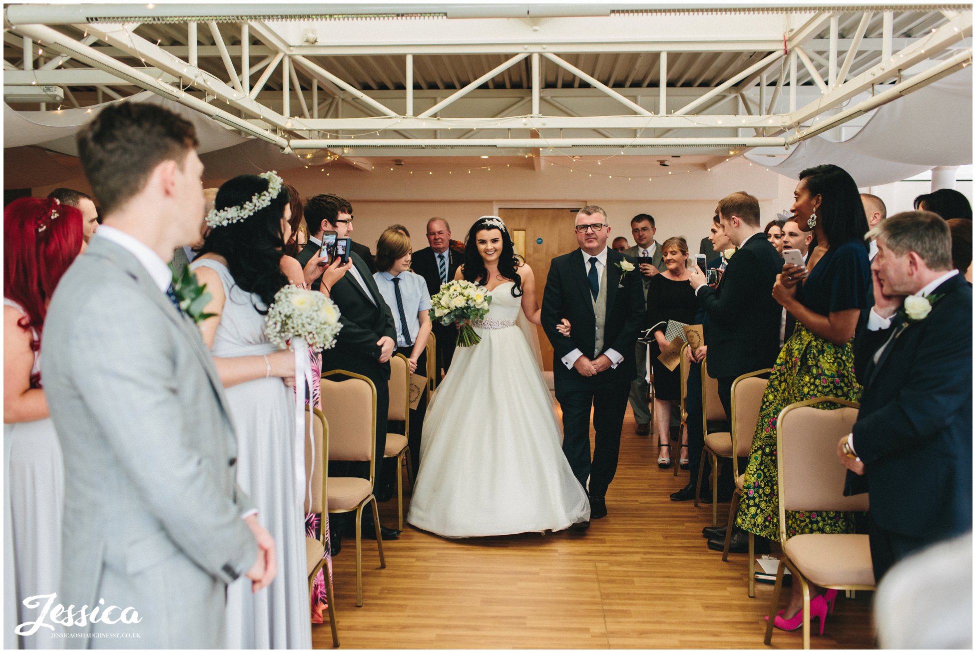 wirral wedding photographer - bride walks down aisle on her wedding day