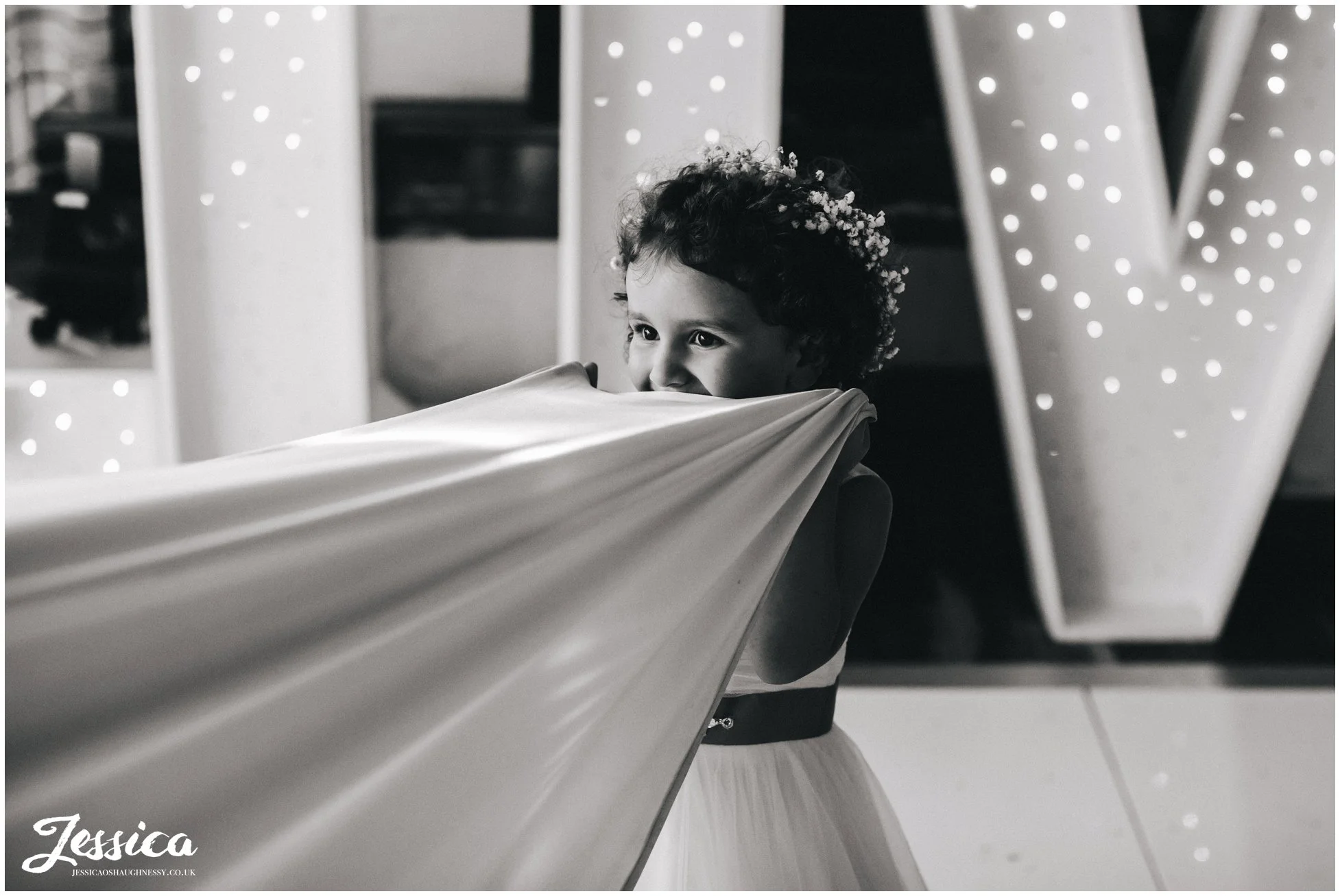 flower girl hides under brides dress