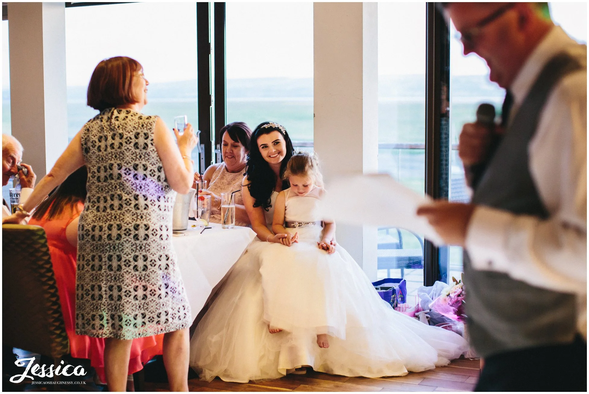 bride watching her father giving his speech