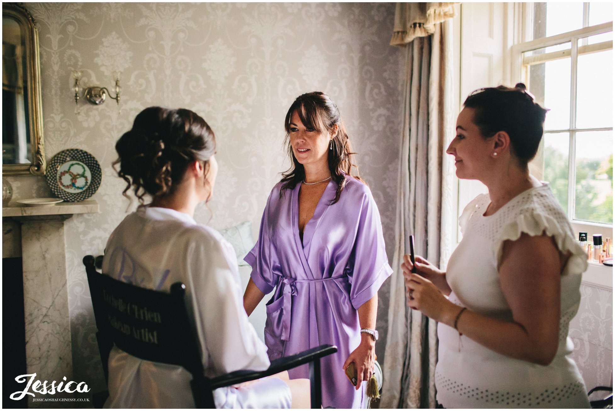 mother of the bride admiring brides makeup