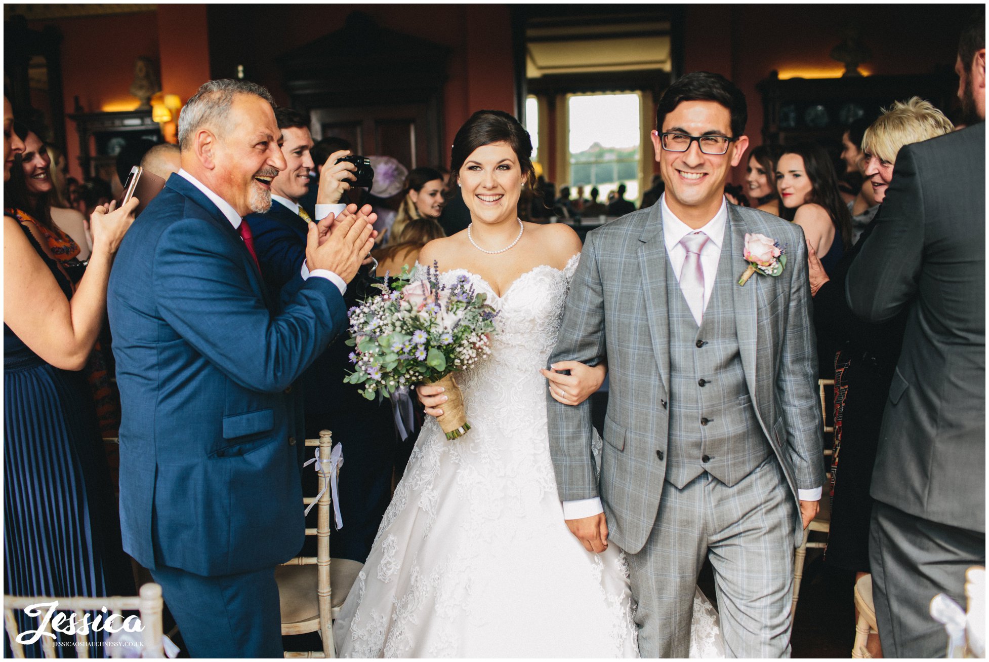 newly wed's exit their prestwold hall wedding ceremony