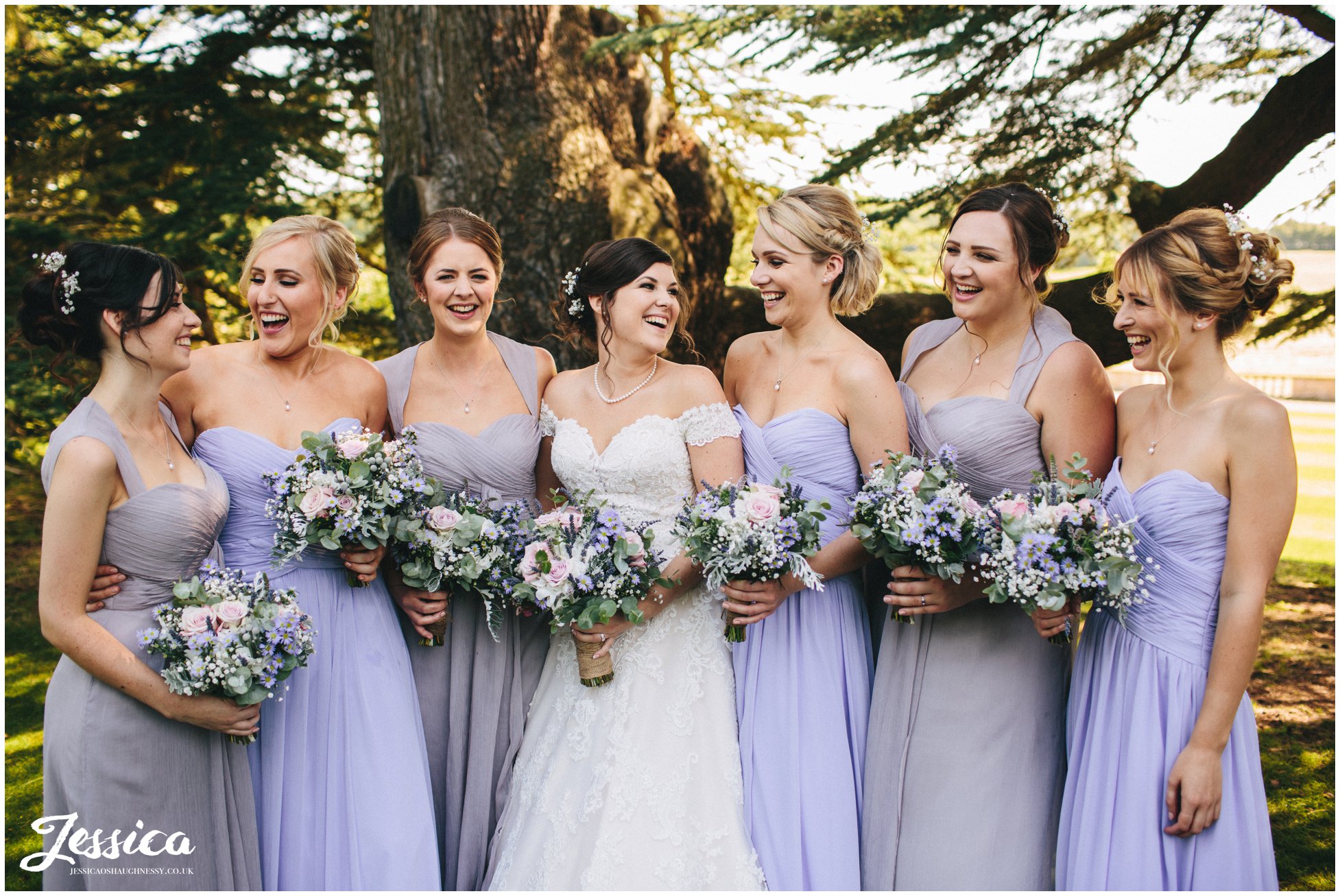 bride & bridesmaids laughing together at the loughborough wedding