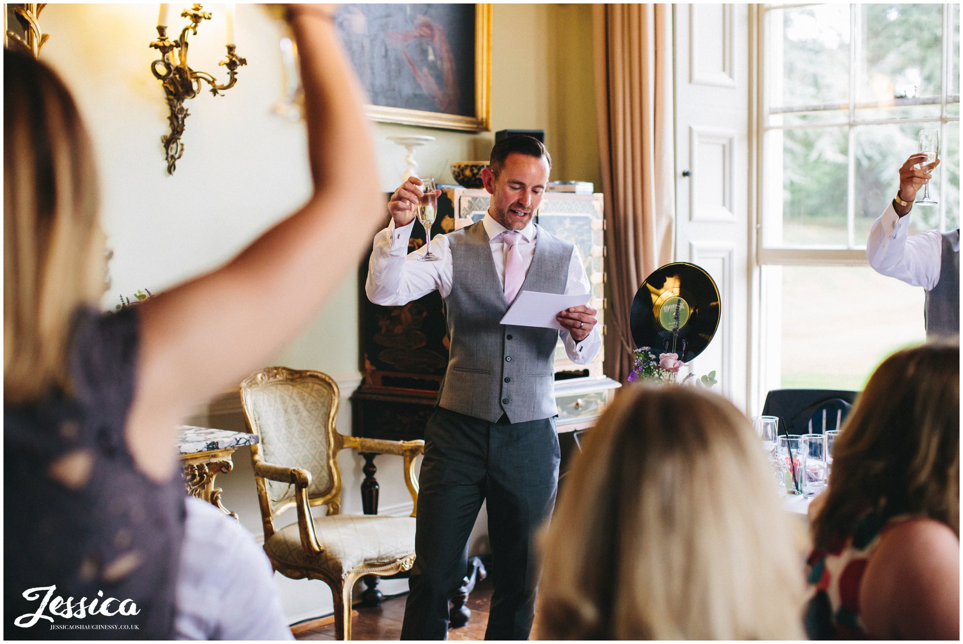 best man raising a toast to the new couple