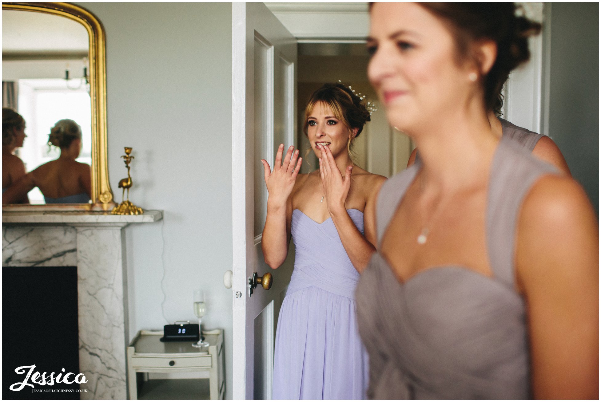 bridesmaid cries looking at bride in her dress