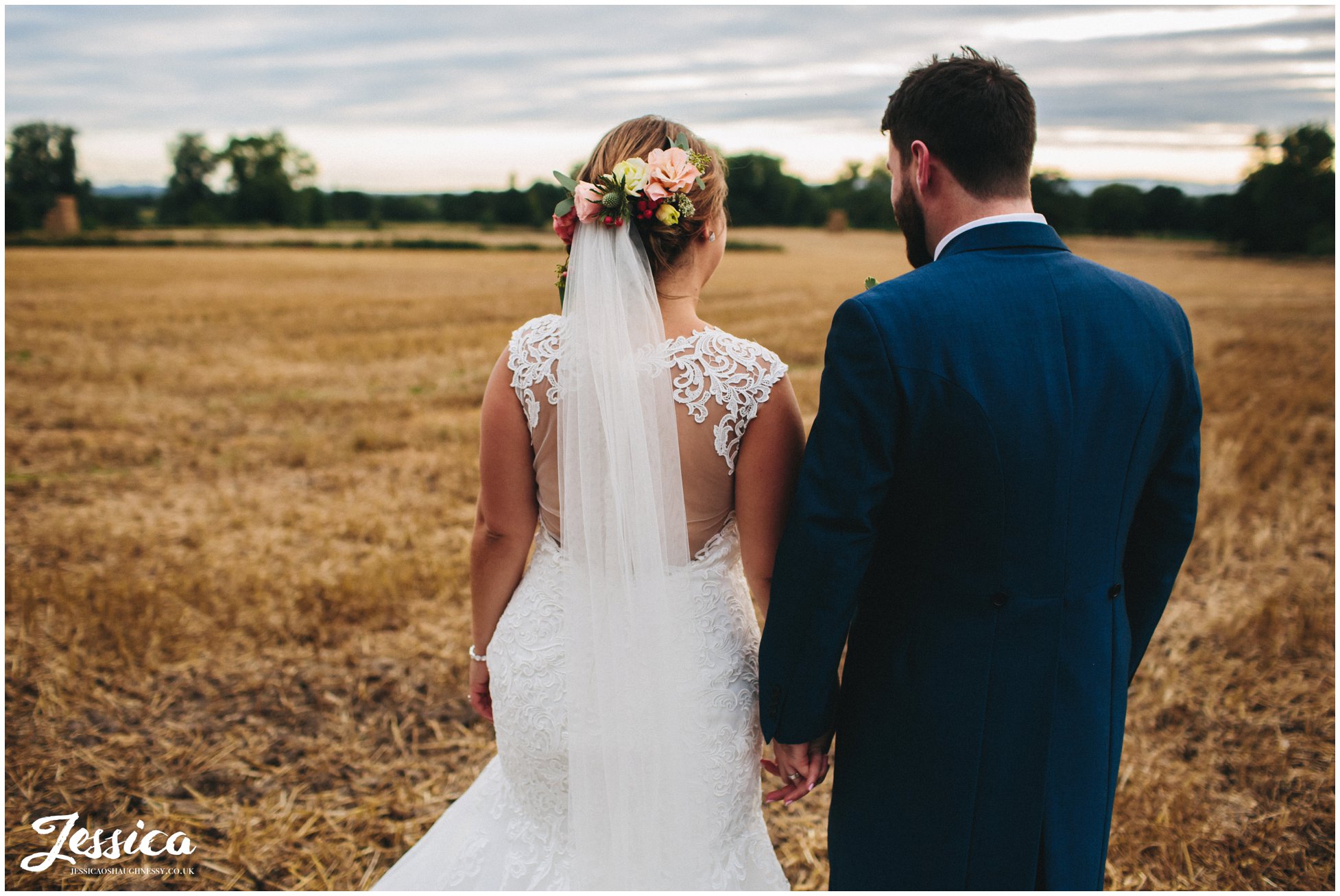 bride & groom wandering through corn field at willington hall