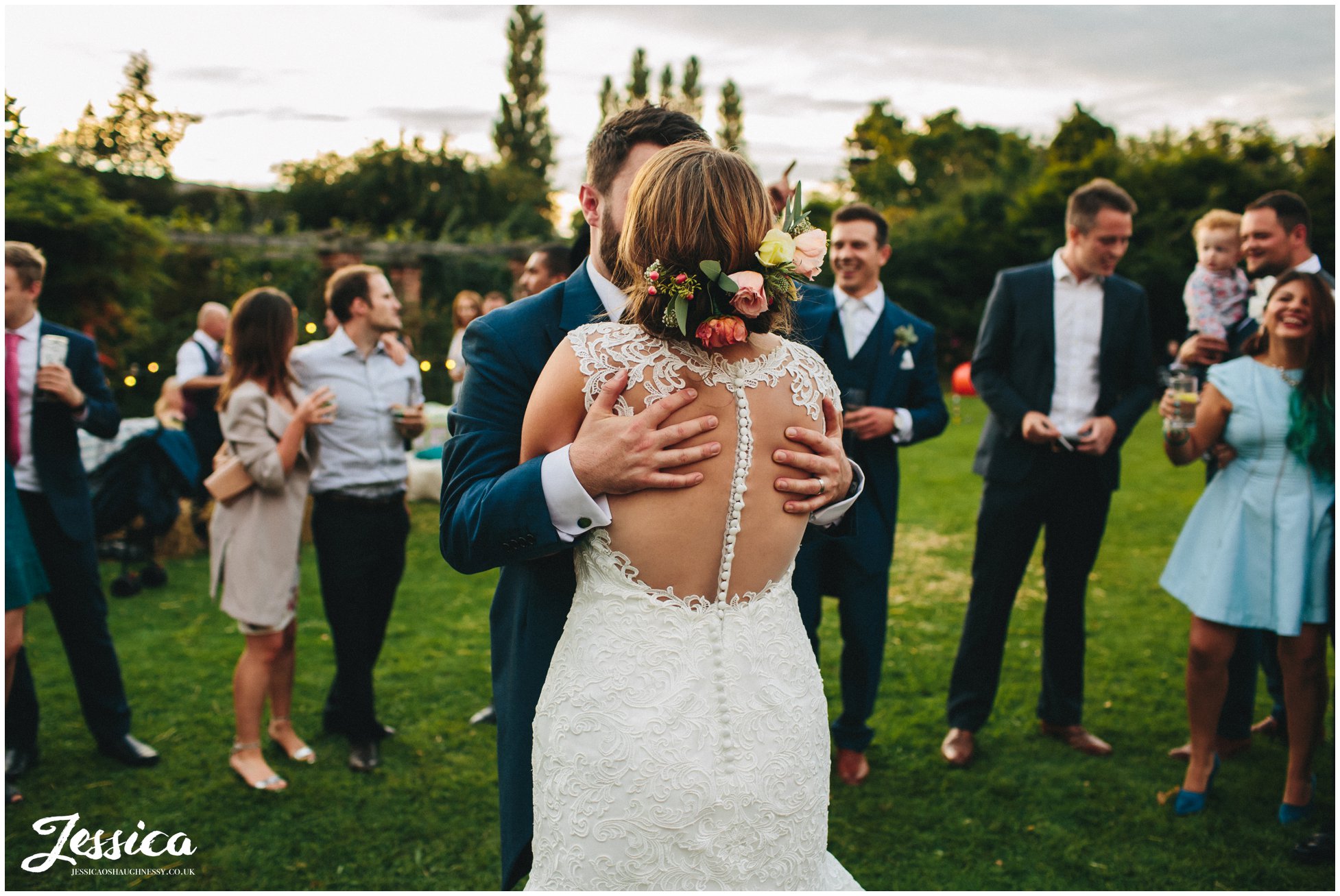newly wed's kiss during their outdoors first dance at willington hall