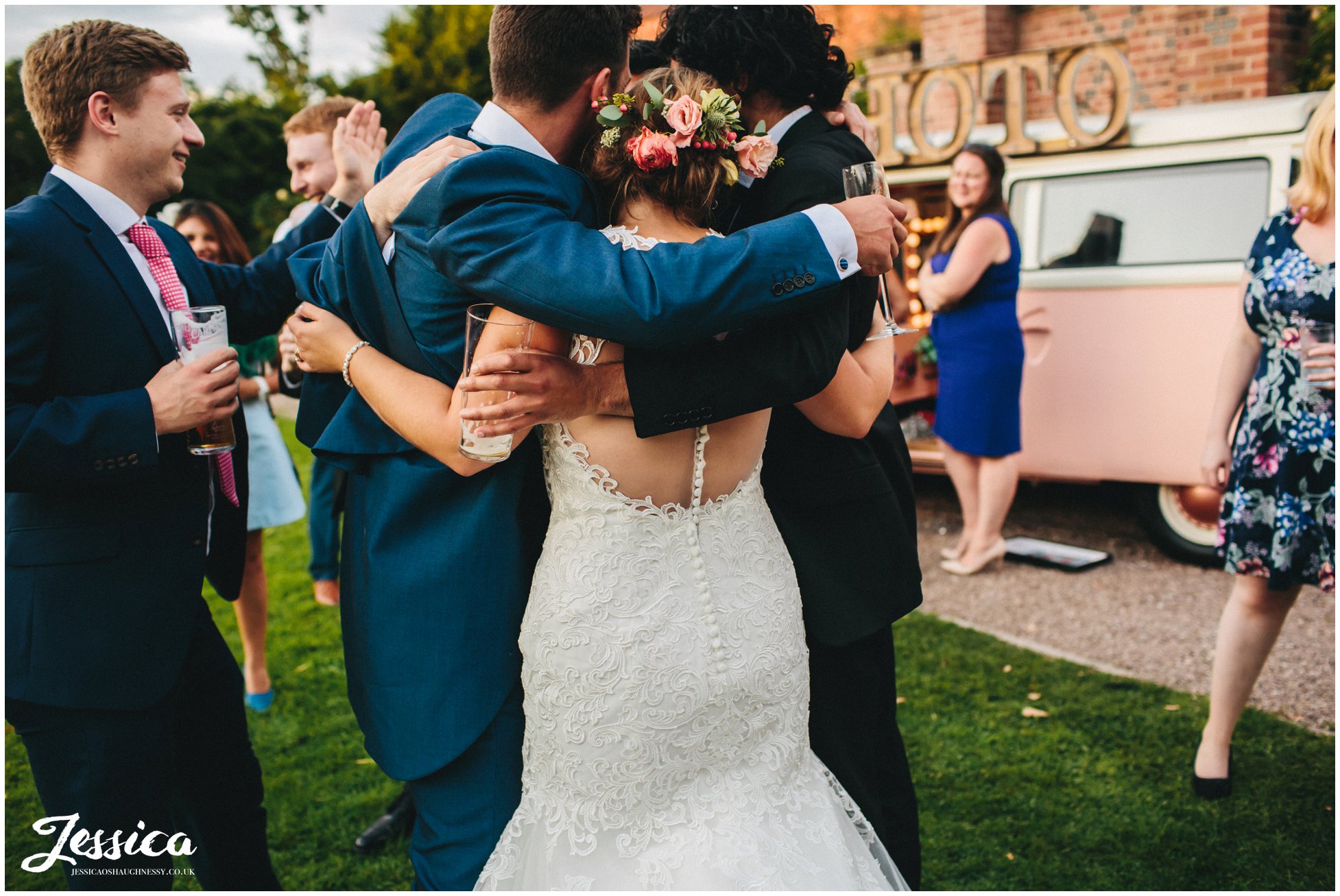 guests hug bride and groom after they finish their first dance