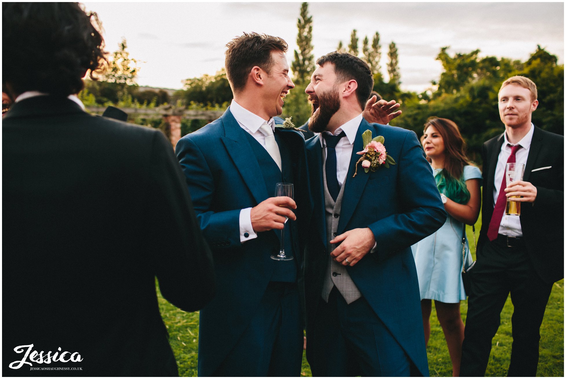 groom and best man hug during a willington hall wedding reception