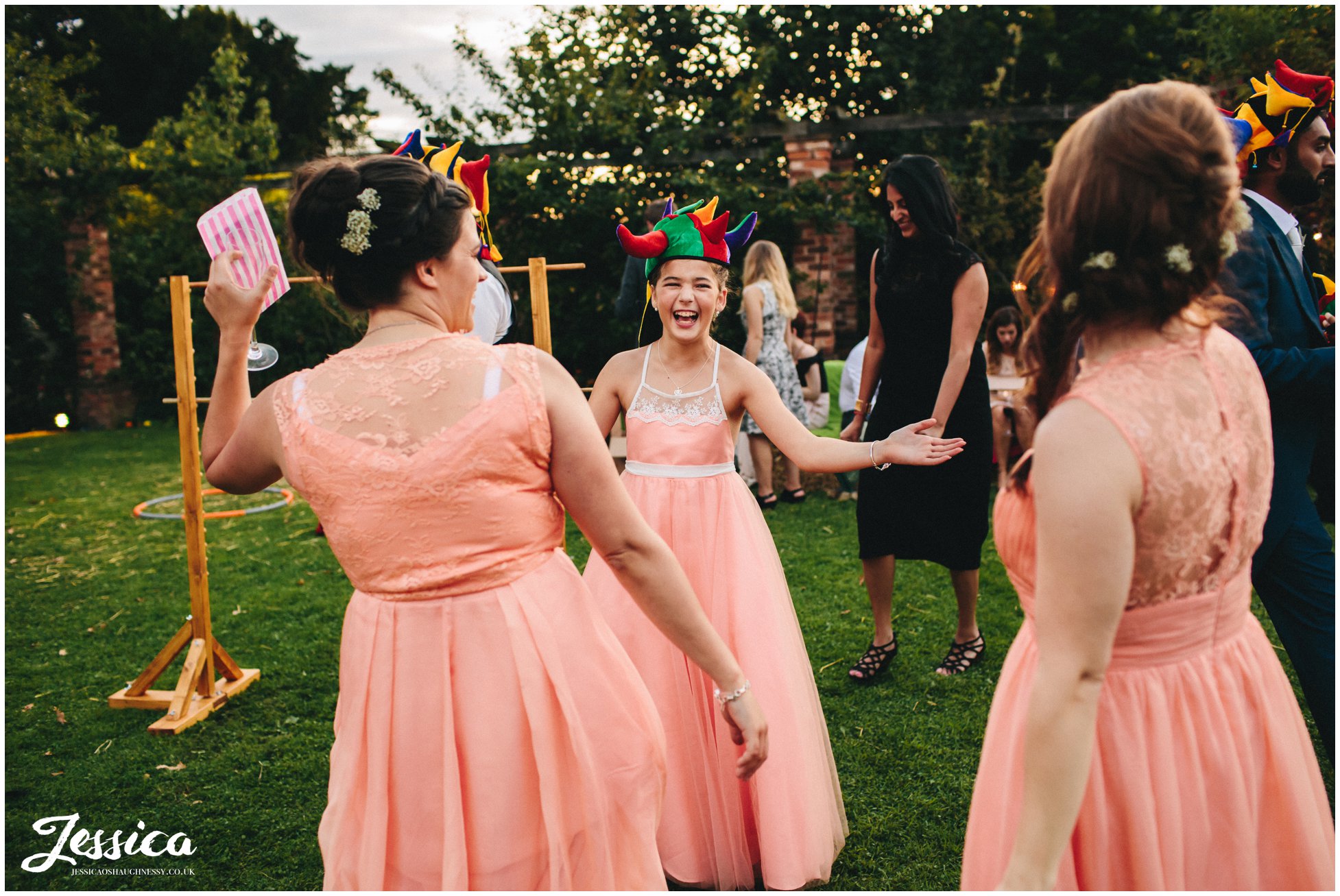 bridesmaids laughing wearing joker hats
