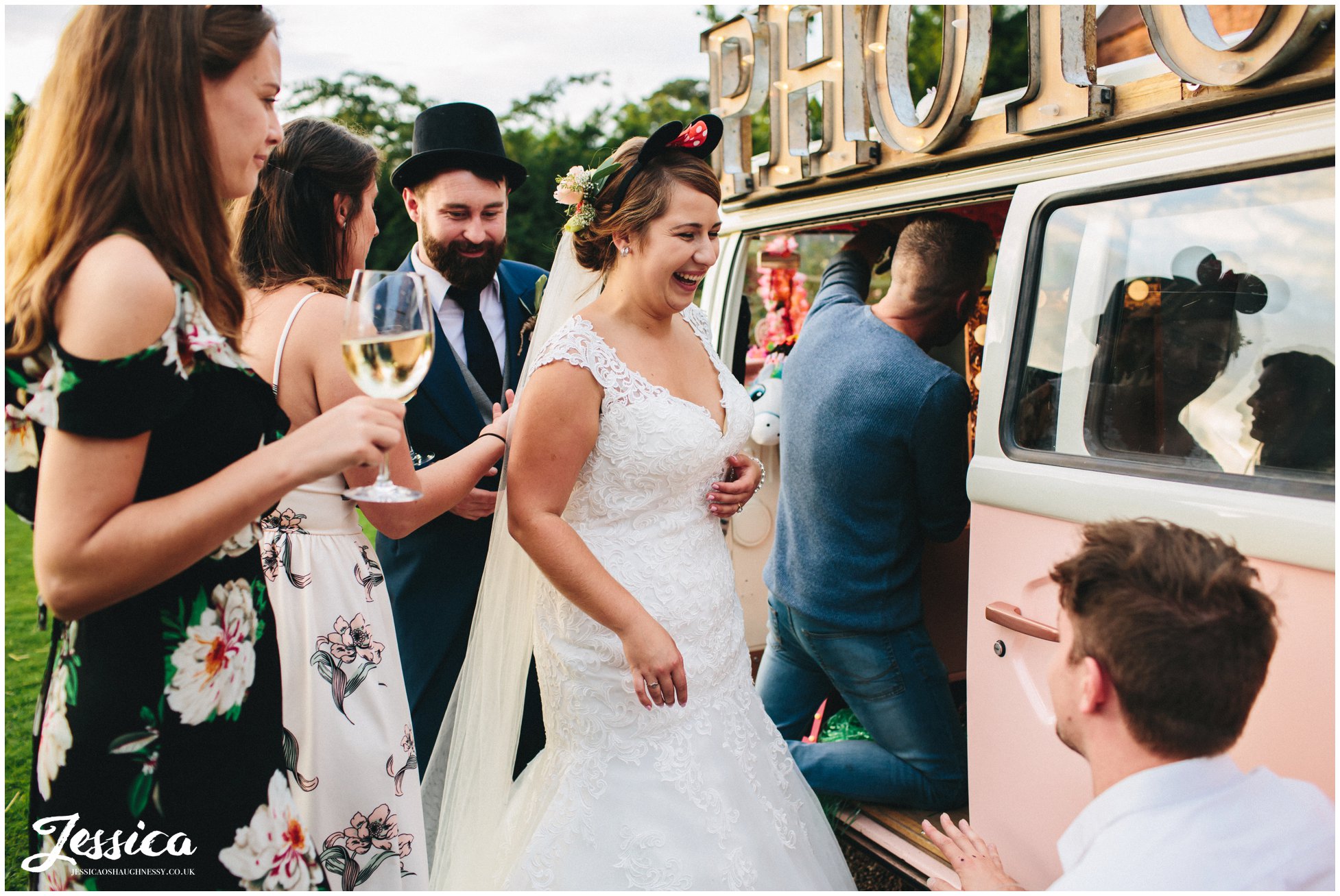 bride wears photography props for photo booth