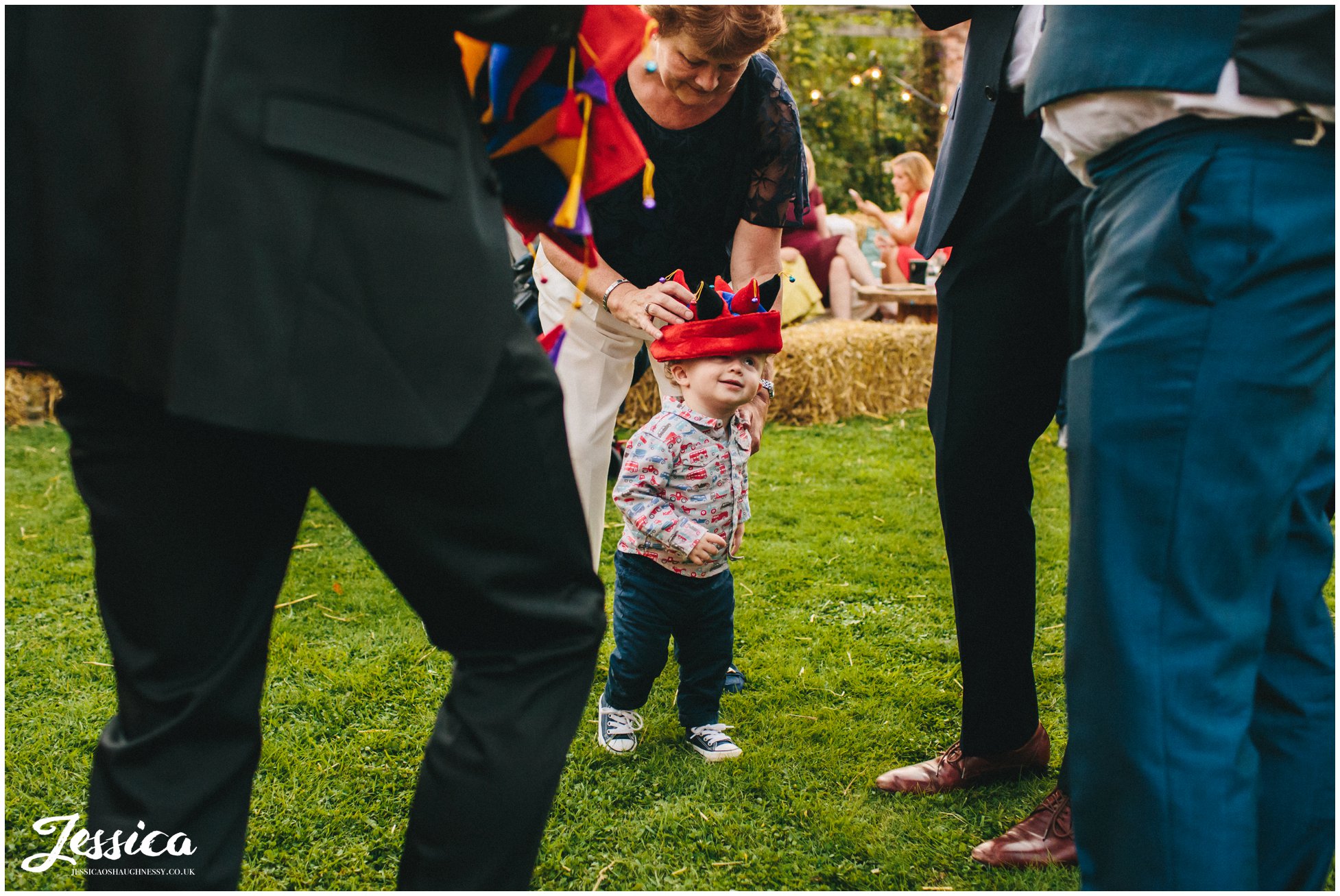 child wears joker hat at a cheshire wedding
