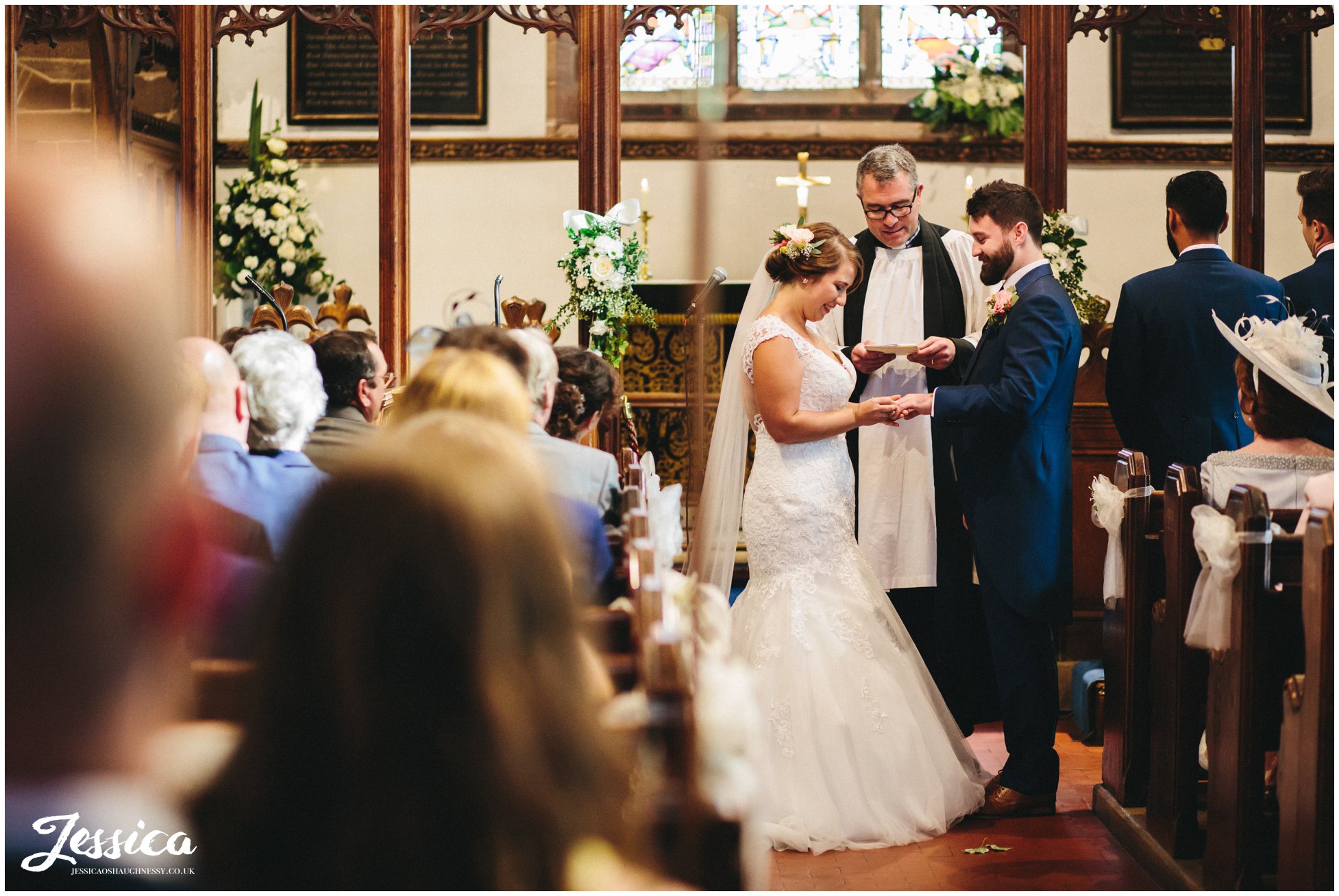 bride & groom exchange rings during their ceremony in cheshire
