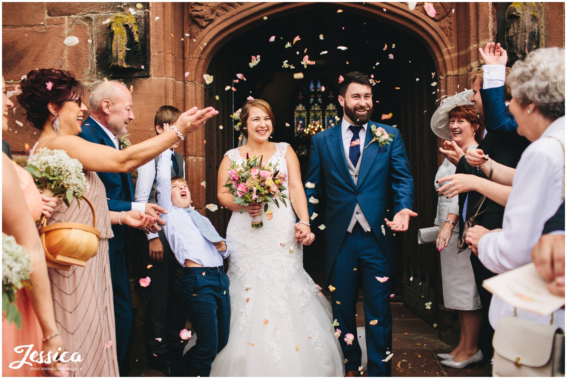 bride & groom exit church with a confetti line