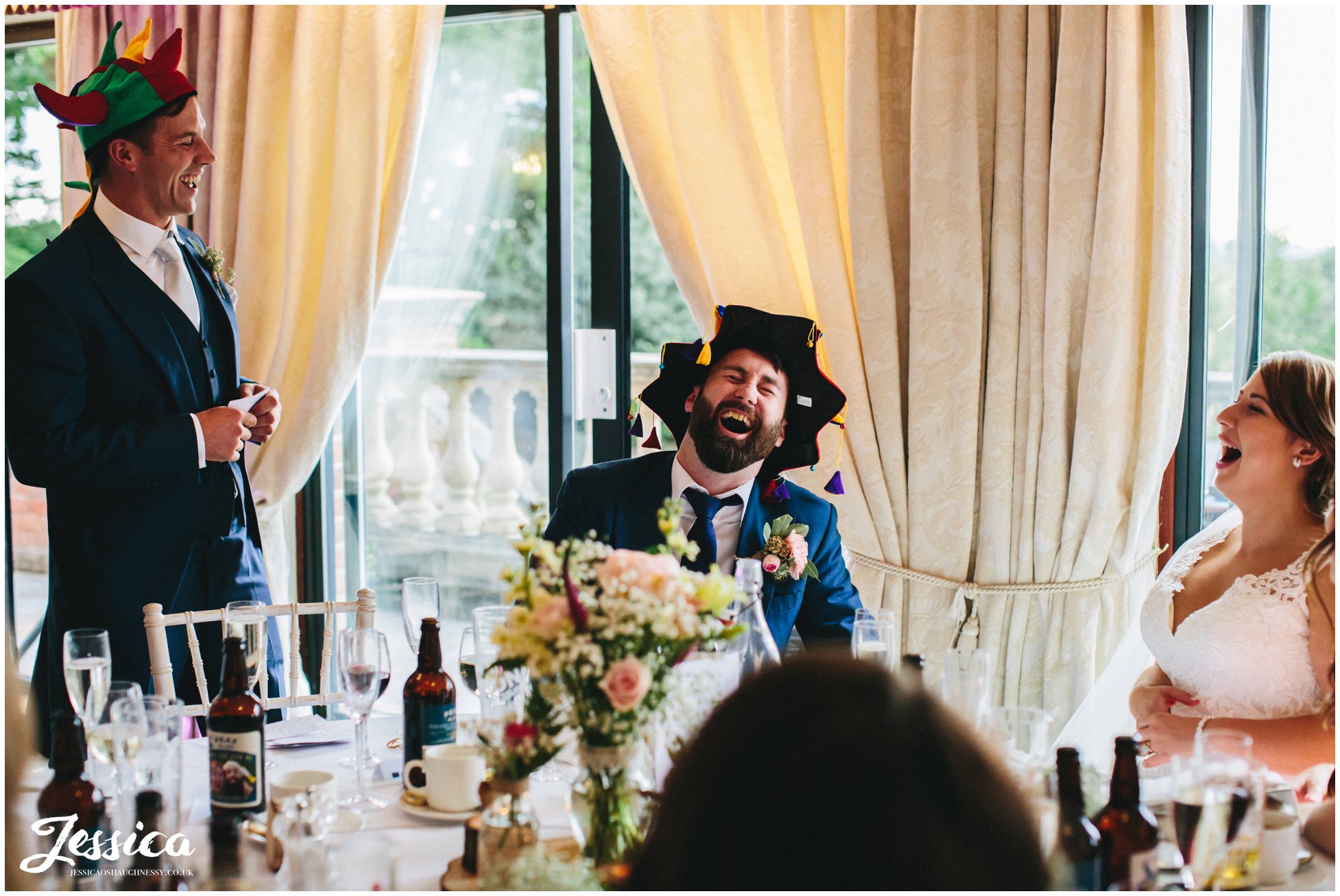 best man gives his speech whilst wearing a jokers hat