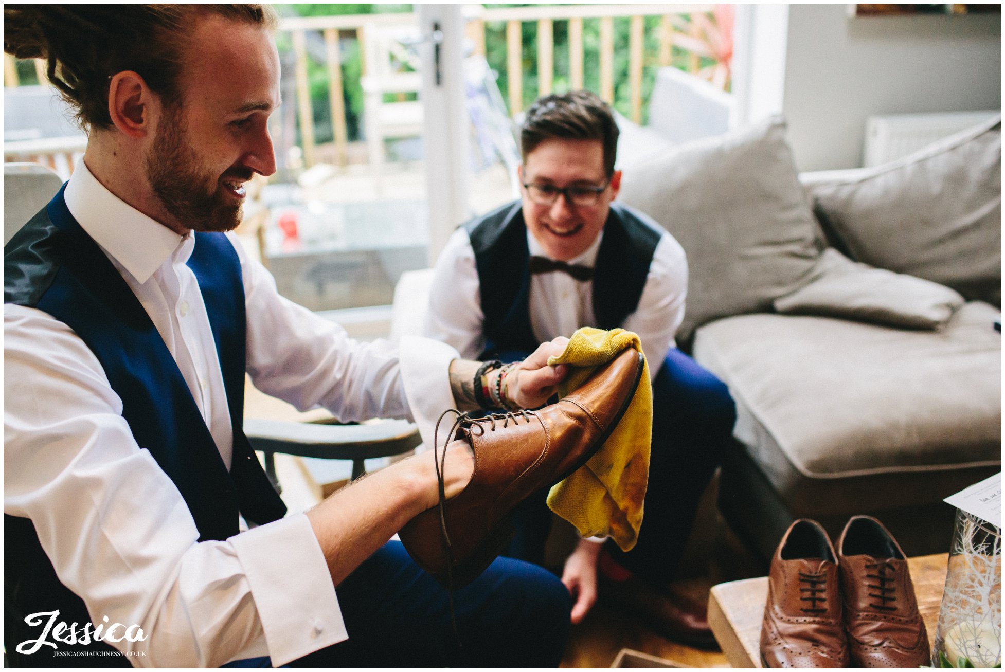 groomsmen polish their shoes before the wedding
