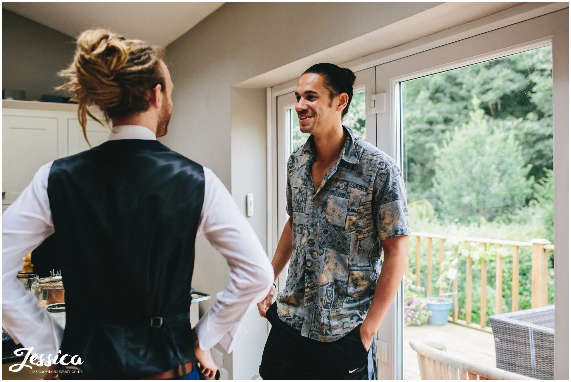 groom jokes around with his best man before the wedding in Cheadle