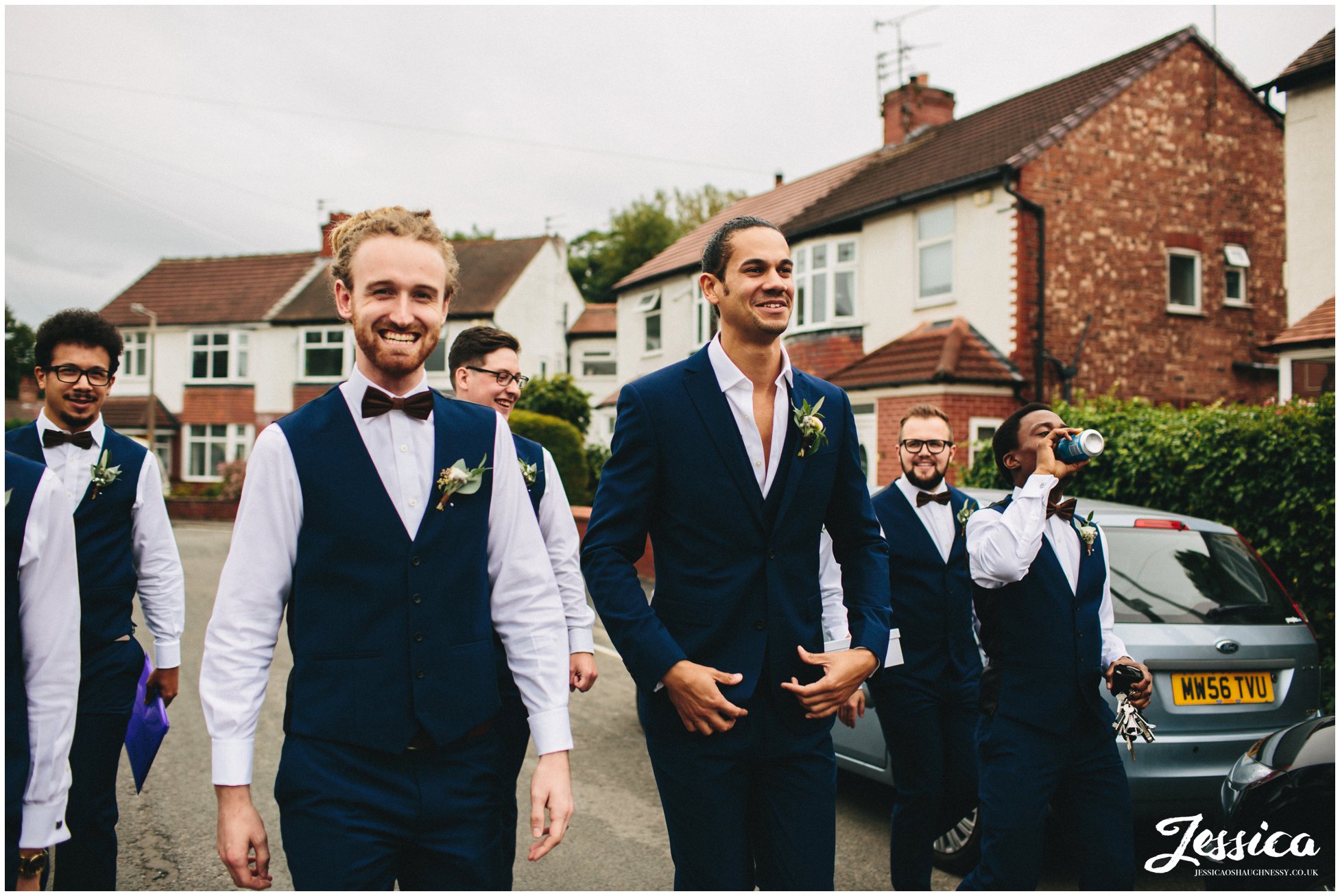 groomsmen walk down the road to the church in cheadle