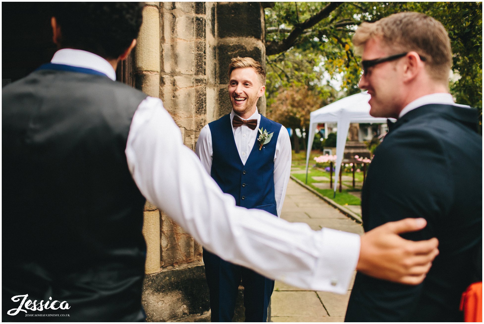 groomsmen greet guests at cheadle church