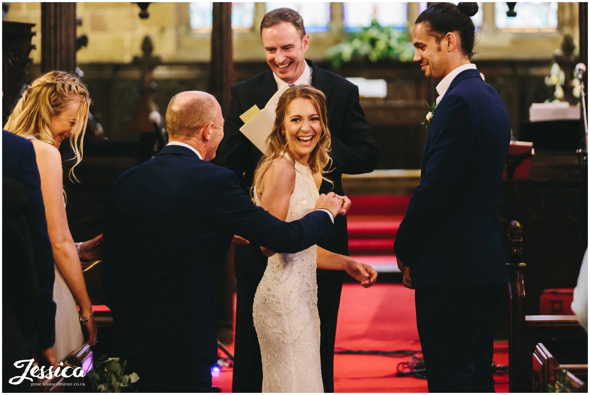 father of the bride gives daughter hand to her groom