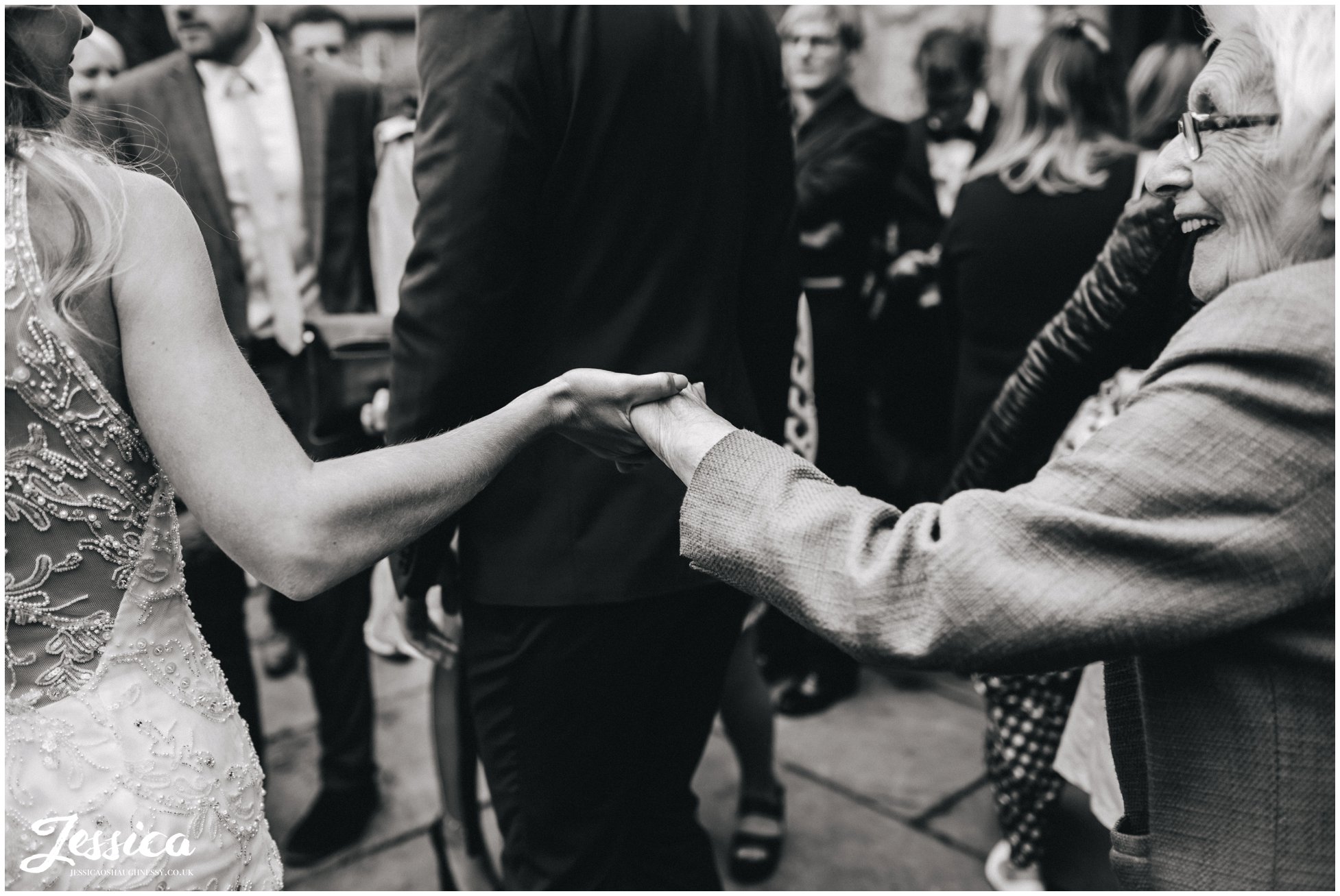 bride holds her grandmas hand