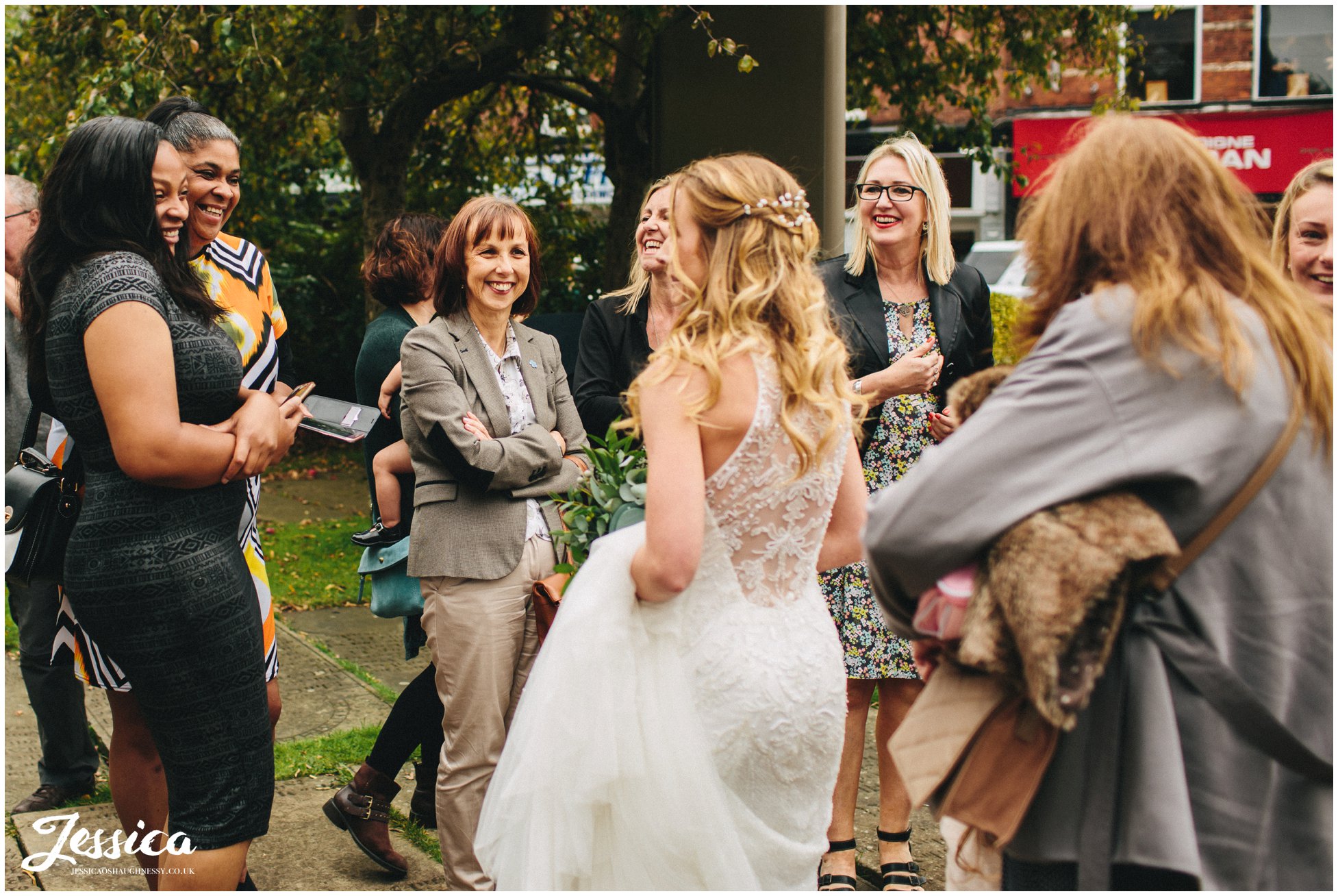 bride greets her friends after the ceremony in cheadle