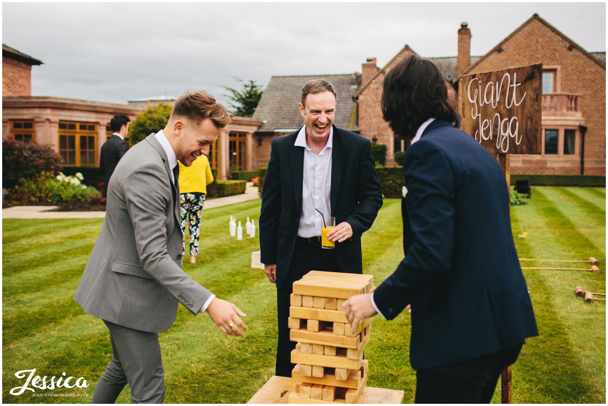 guests enjoy playing giant jenga at the cheshire wedding