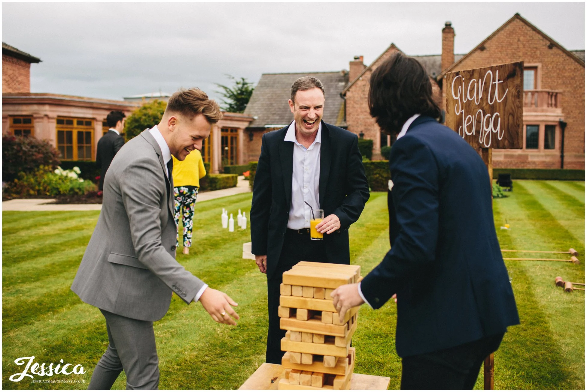 guests enjoy playing giant jenga at the cheshire wedding