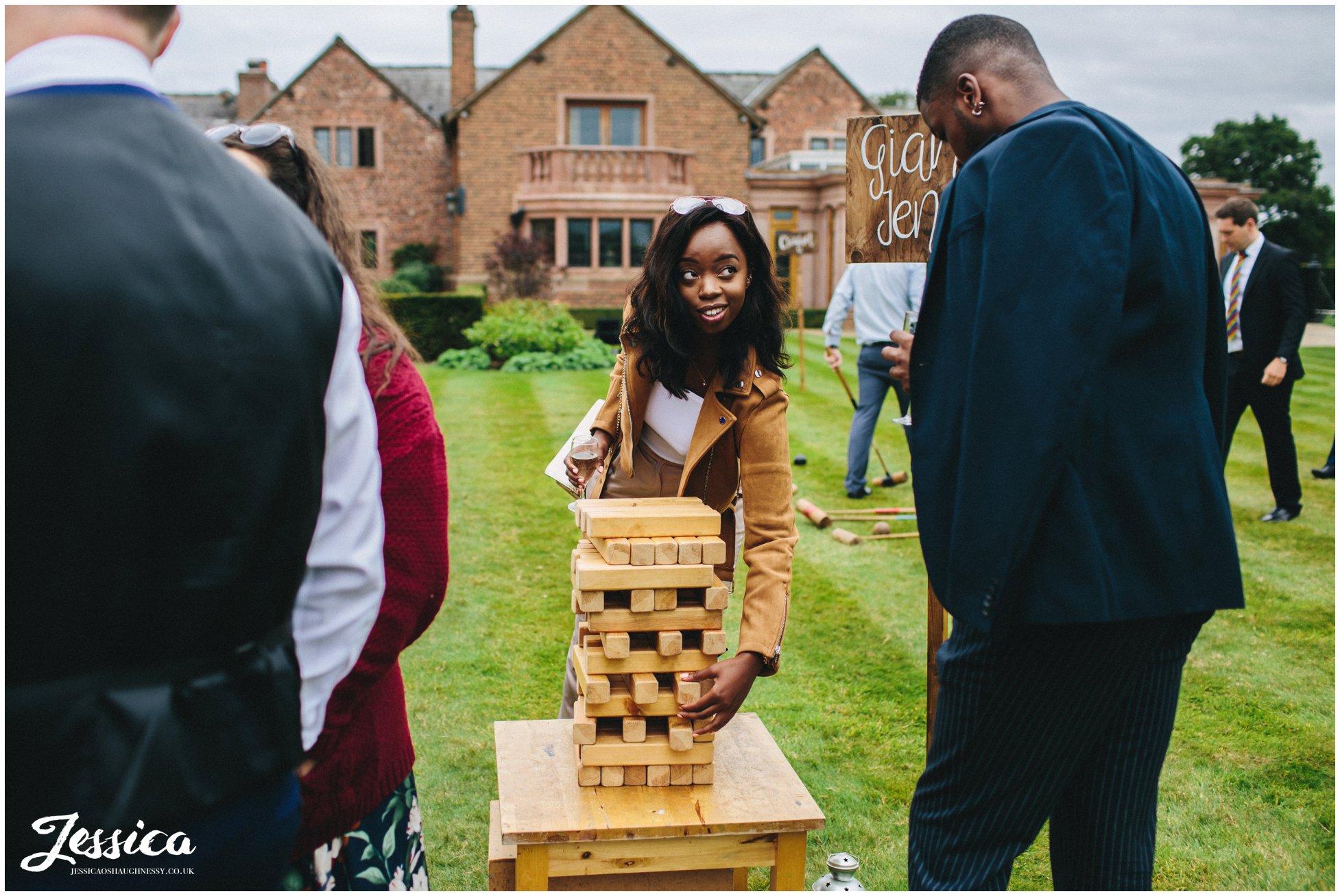 wedding guests play jenga on the lawn in cheshire