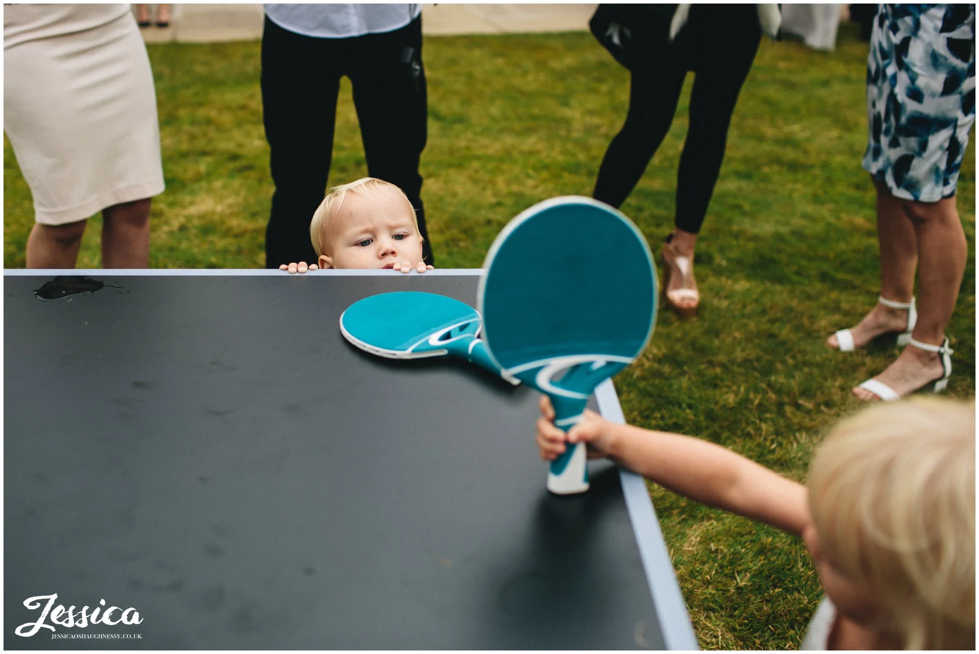 child tries to play ping pong but can't reach