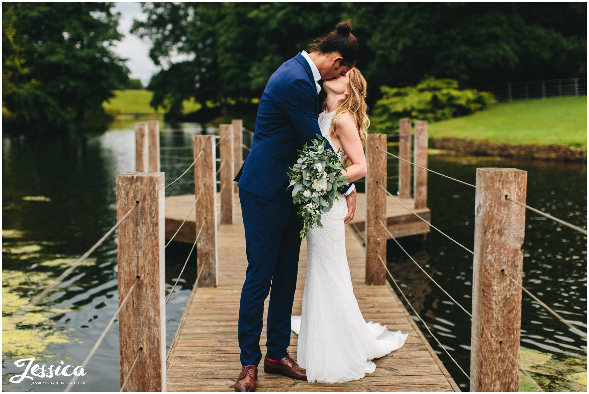 newly wed's kiss on the jetty at merrydale manor in cheshire