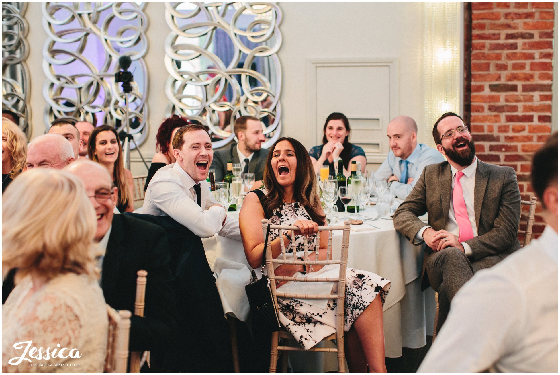 guests laughing during the grooms speech at merrydale manor in cheshire