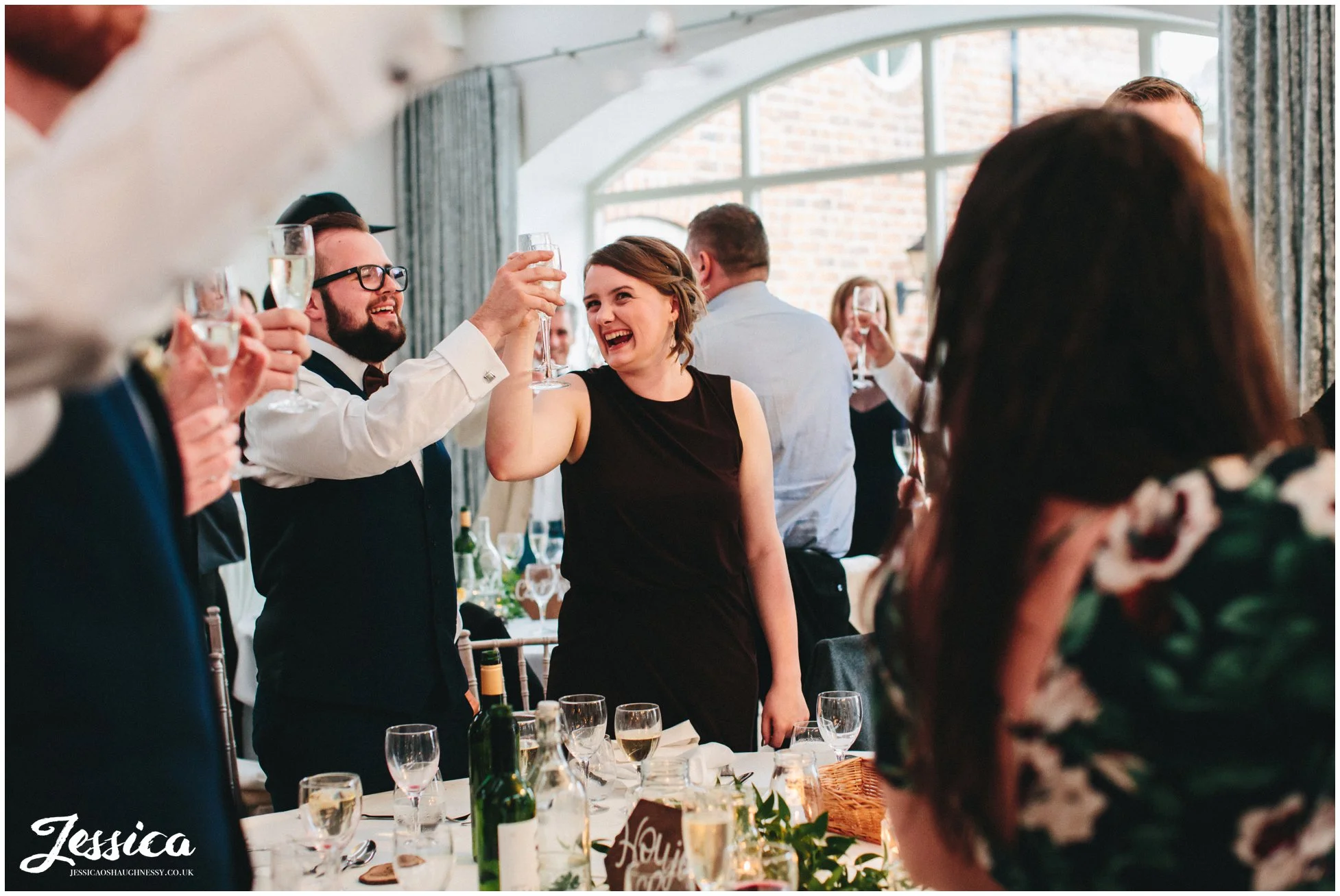 guests cheers the happy couple during the best mans speech