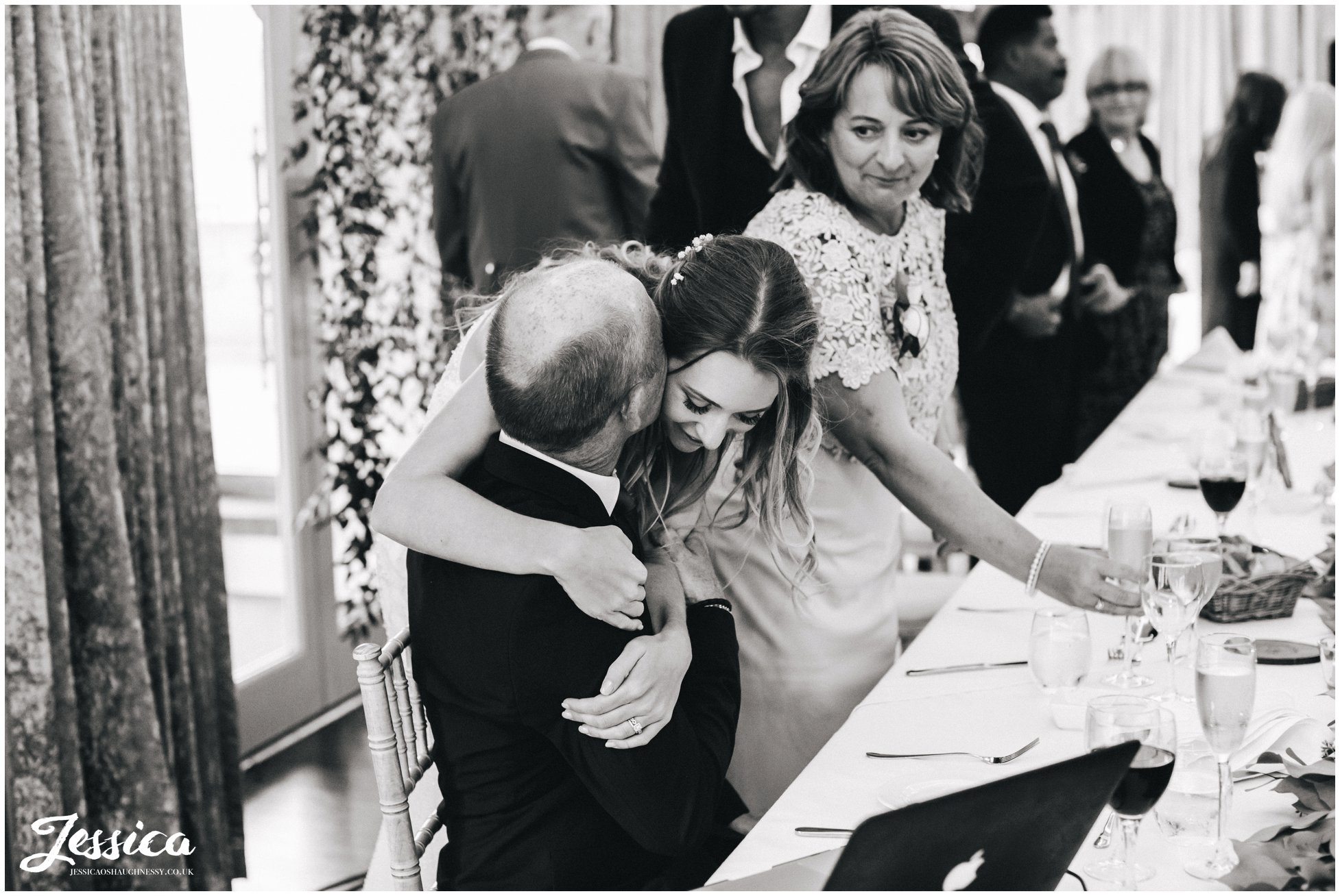 bride hugs her father in thanks to his speech