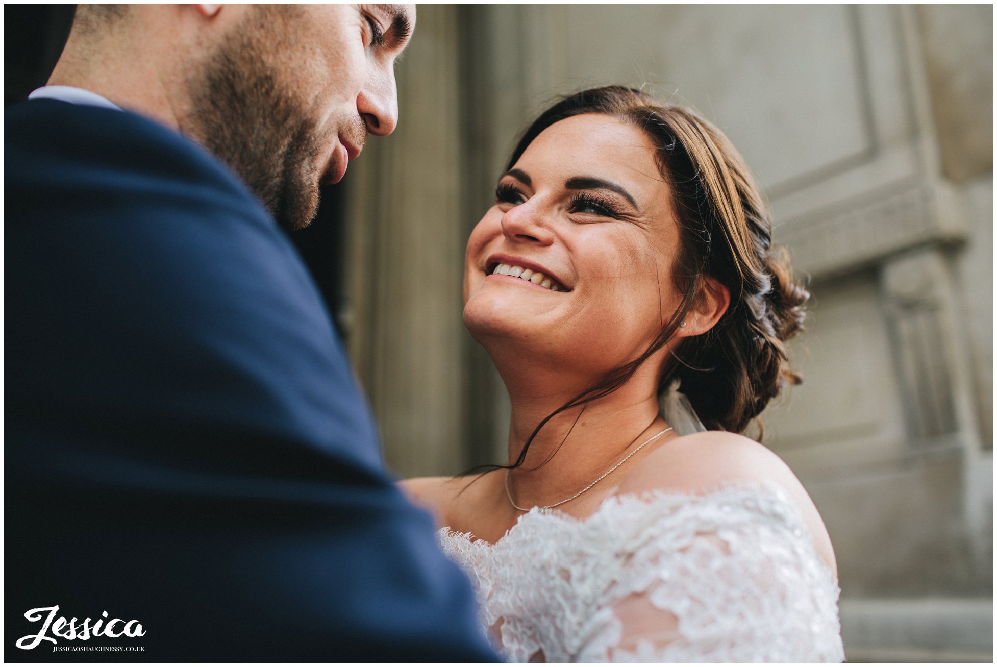 bride smiles lovingly at her husband