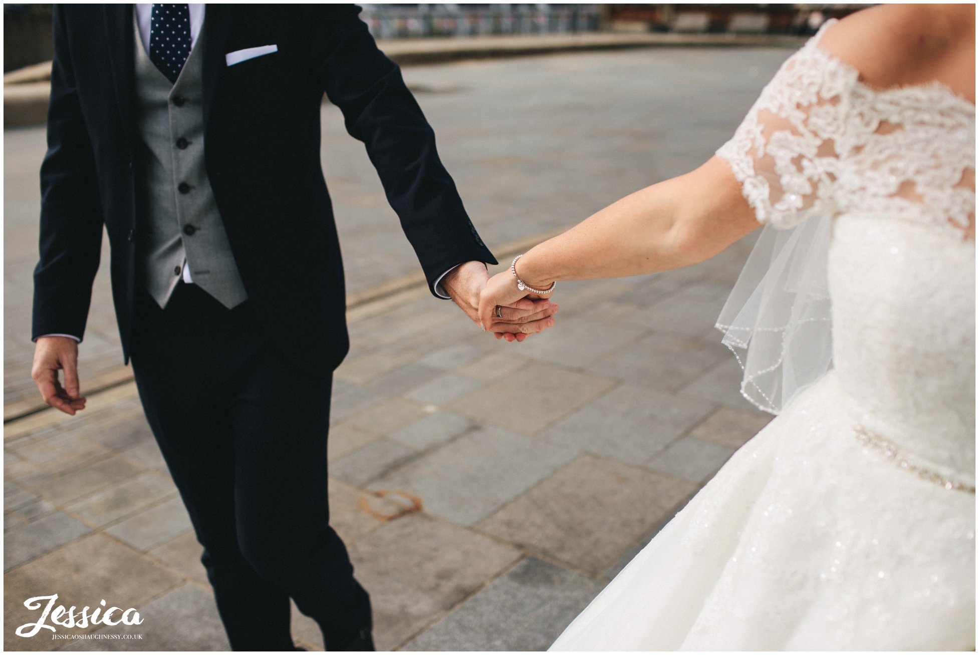 close up of husband and wife holding hands