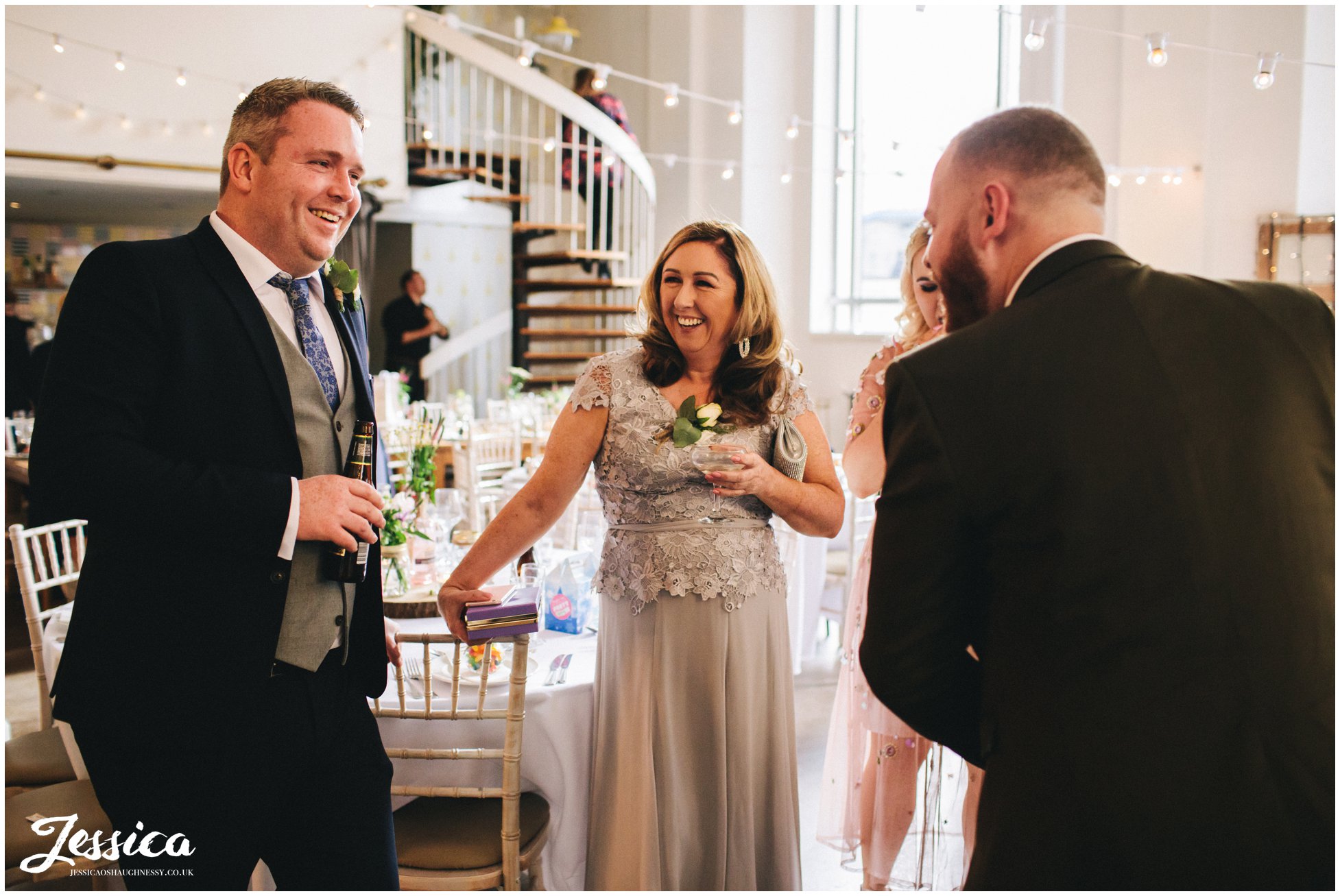 guests laughing during the drinks reception