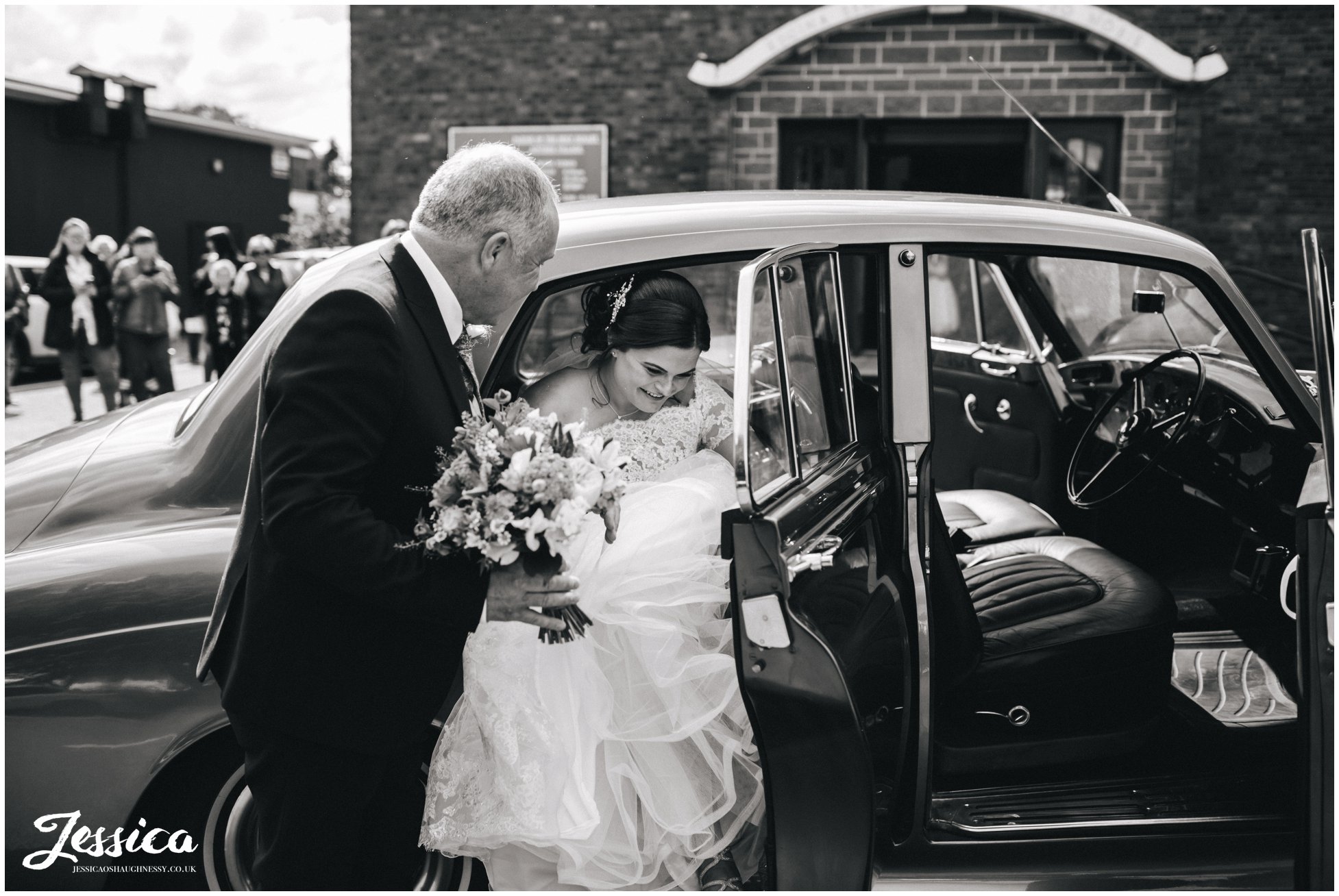 bride gets out of wedding car at Holy rosary church in Aintree, liverpool