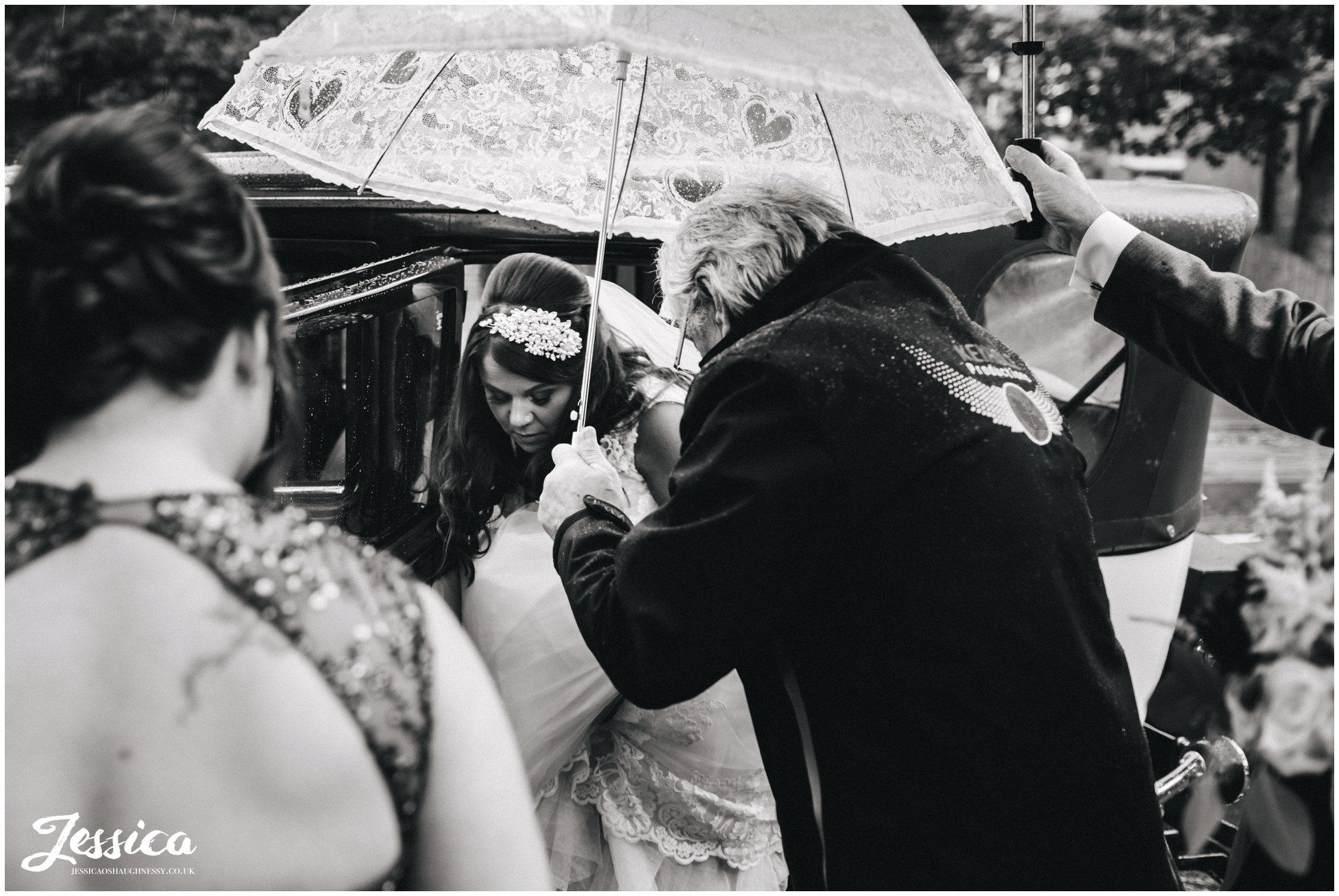 bride is sheltered by umbrellas before the ceremony at Wavertree Holy Trinity Church