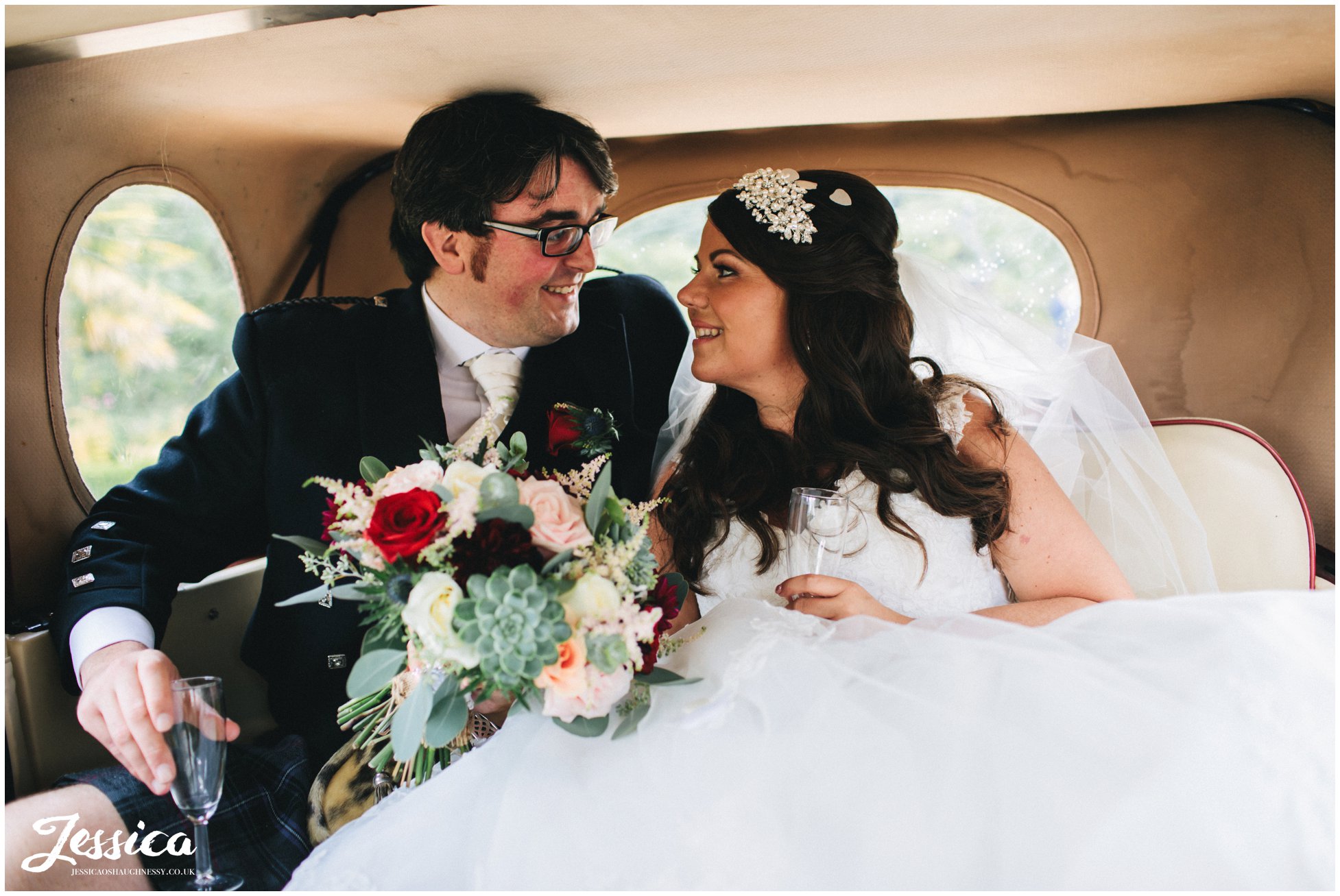 newly wedded couple in their wedding car