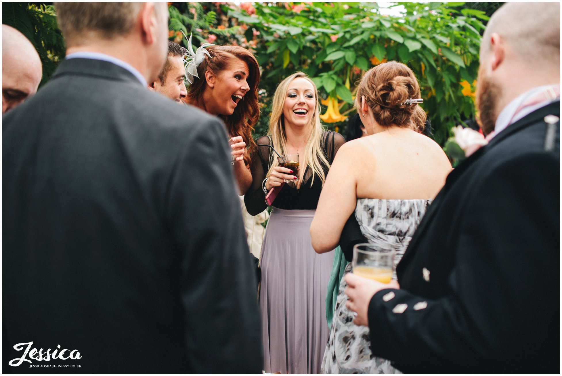 wedding guests laughing during drinks reception