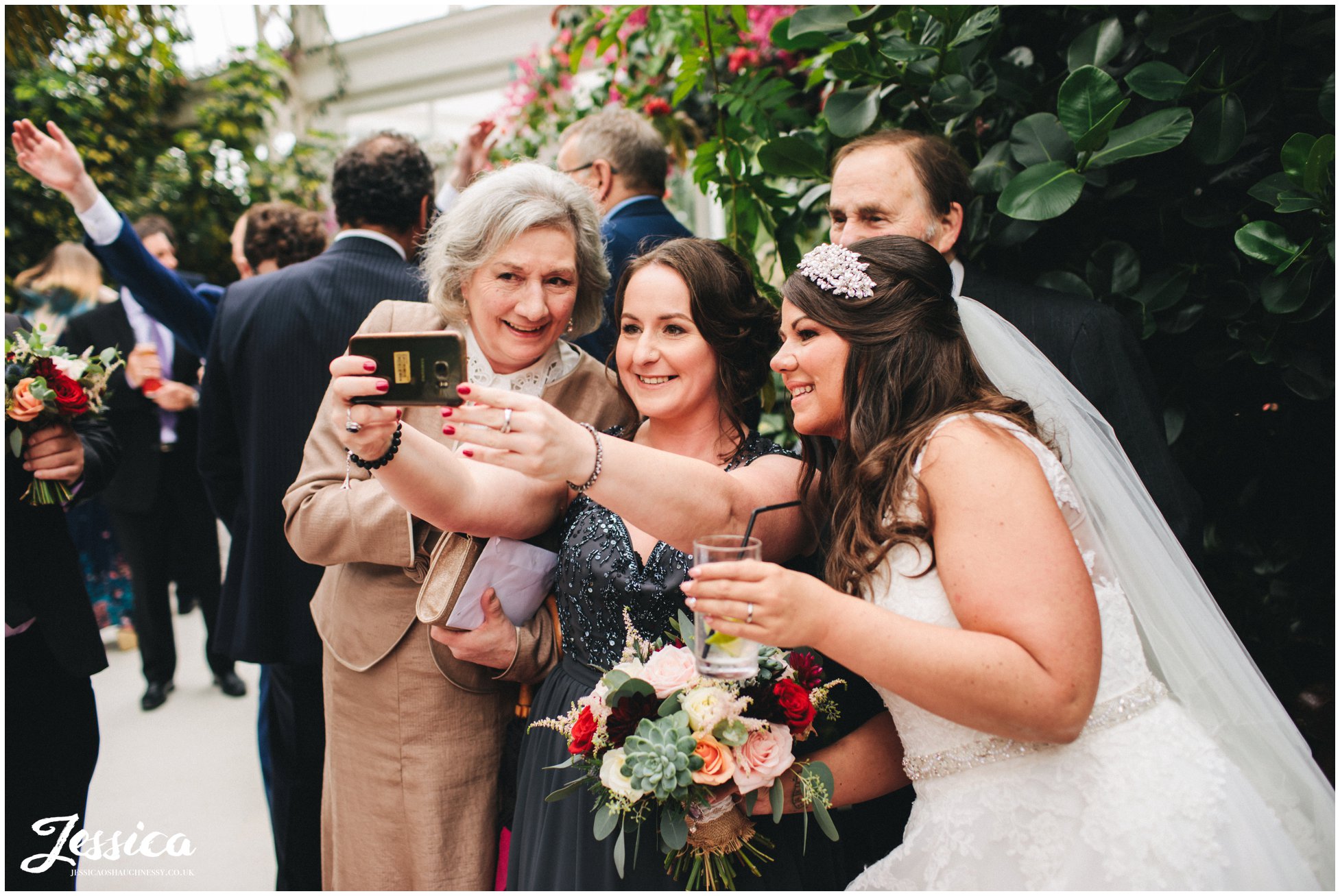 guests take a selfie with the bride
