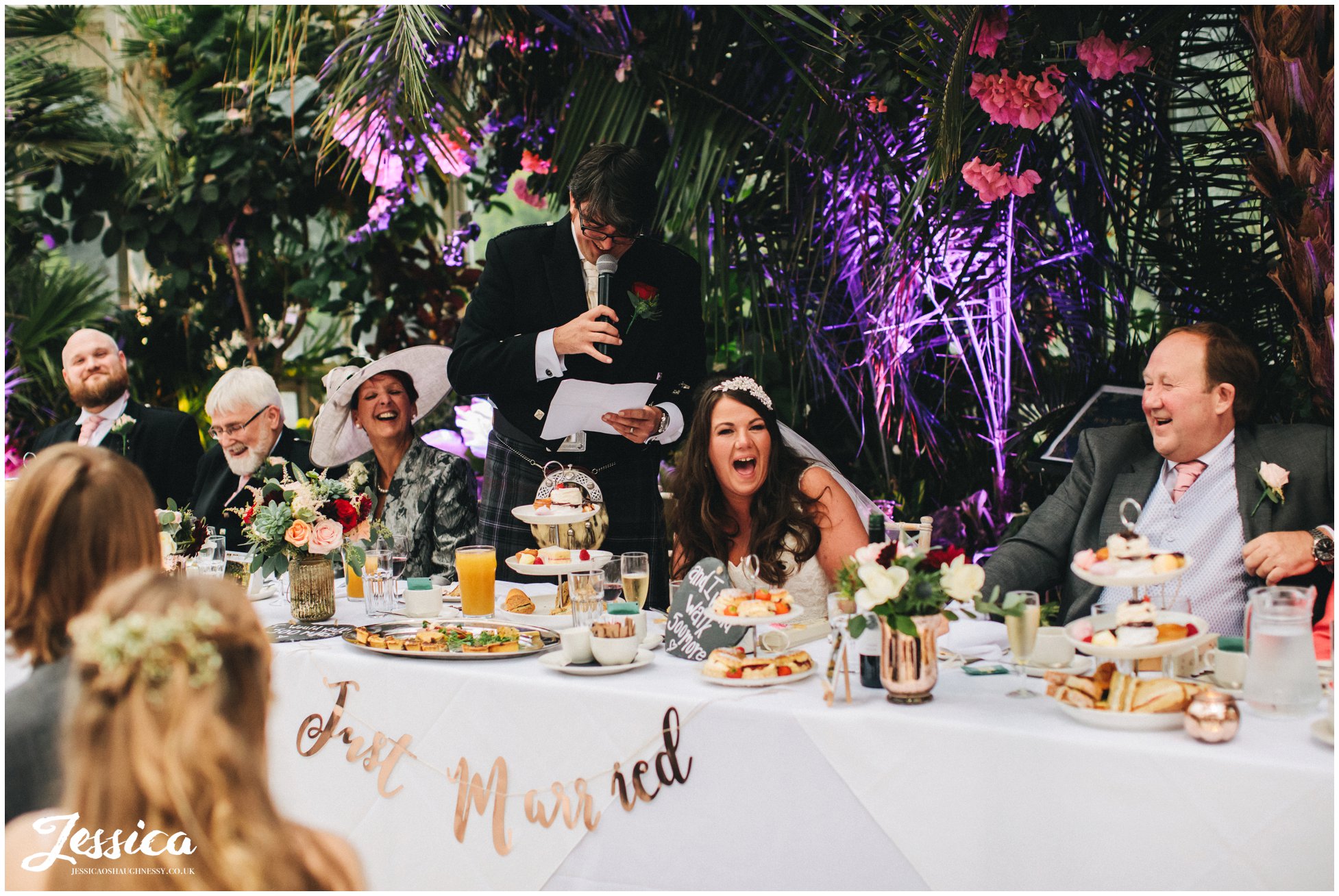 top table laughing during the grooms speech