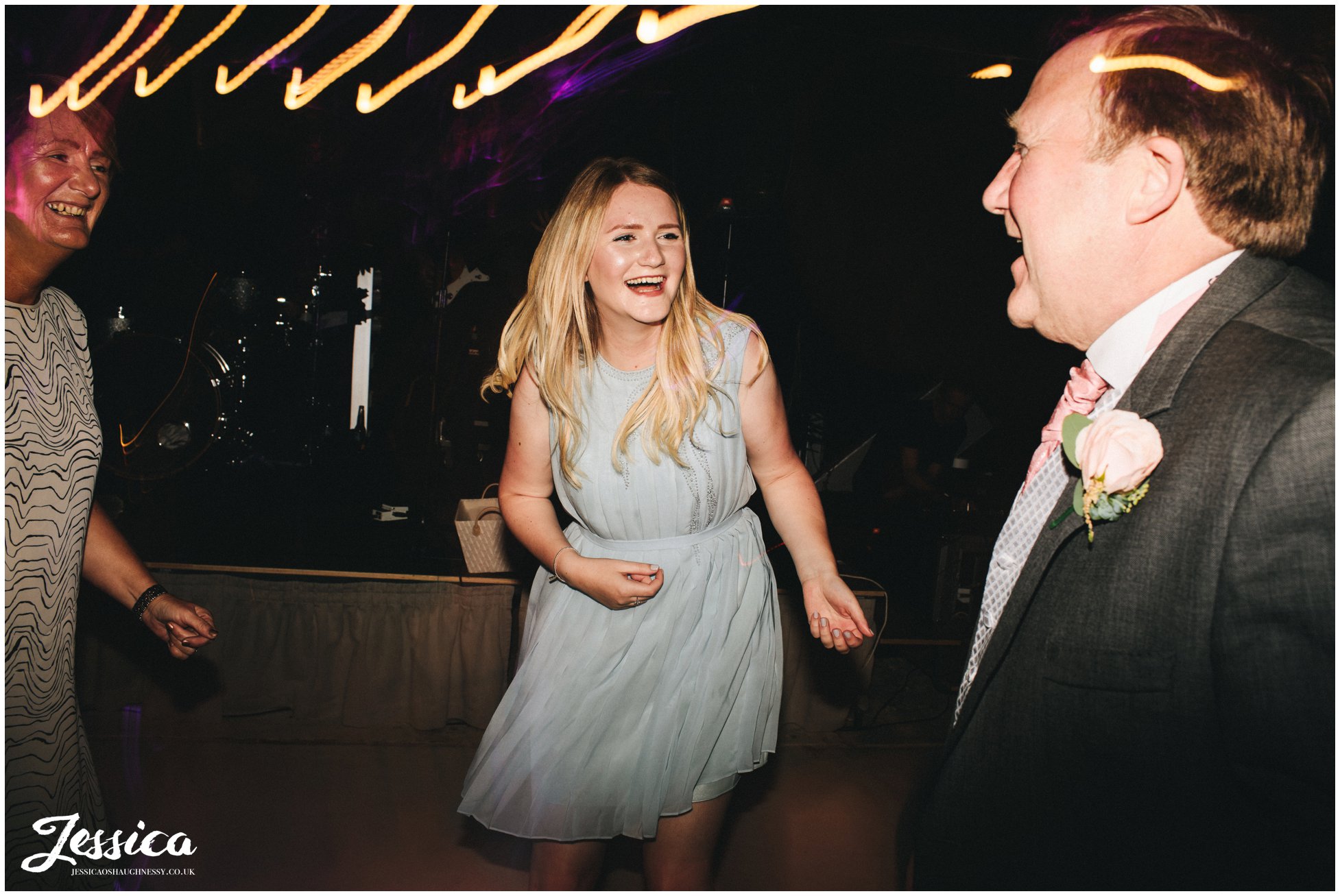 guests laughing on the dancefloor of wedding venue
