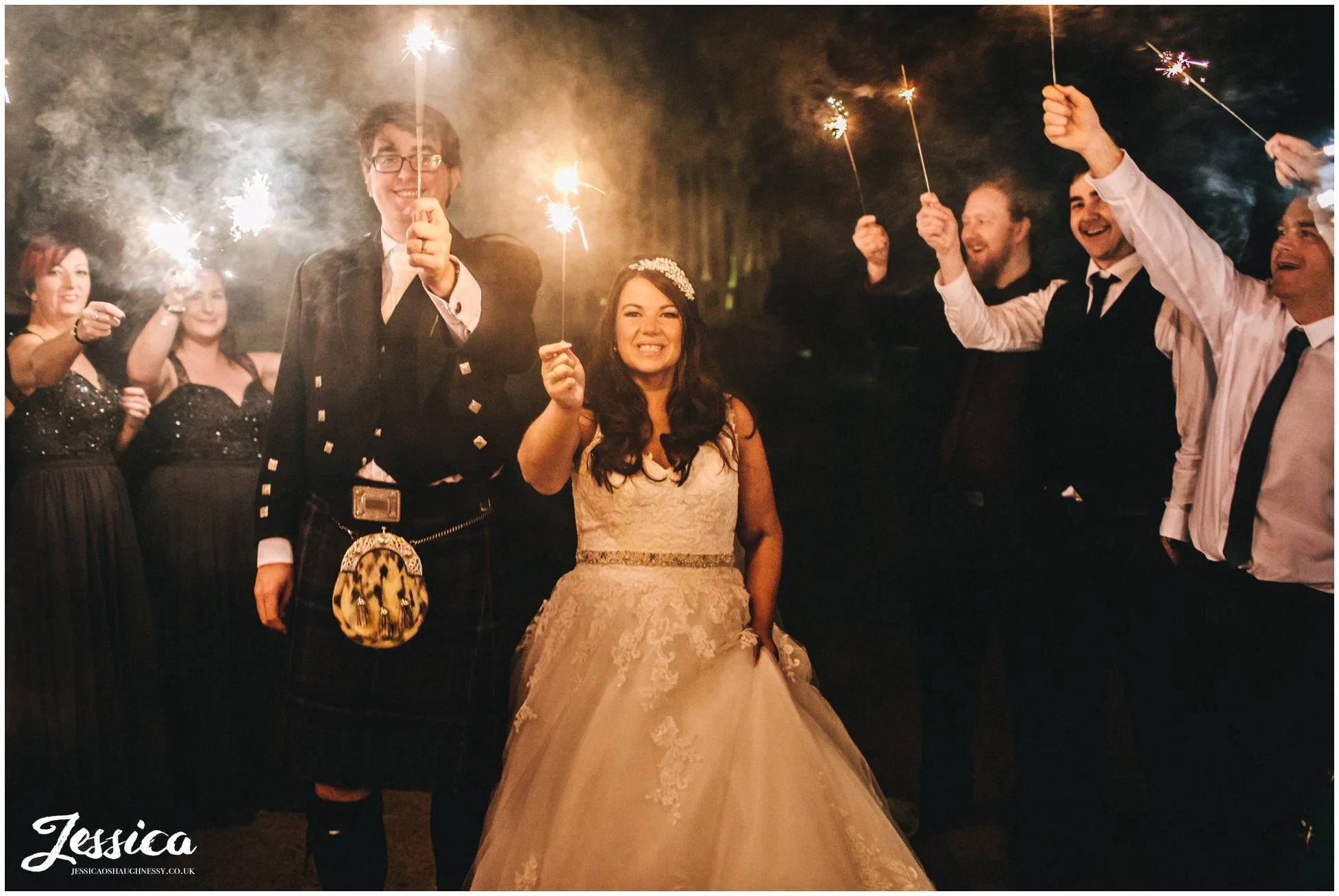 bride and groom holding sparklers at sefton palm house in liverpool