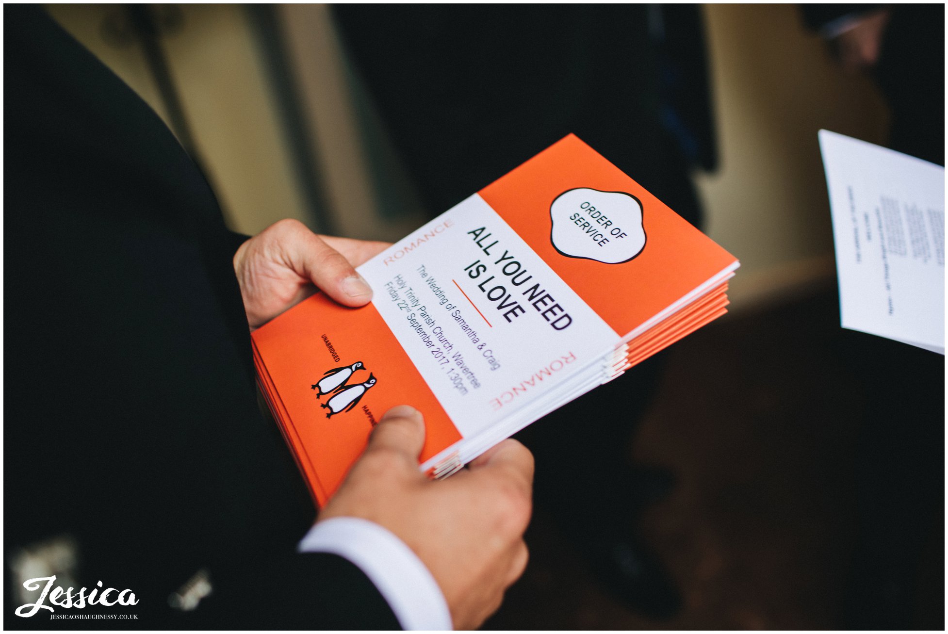 groomsman hands out order of service
