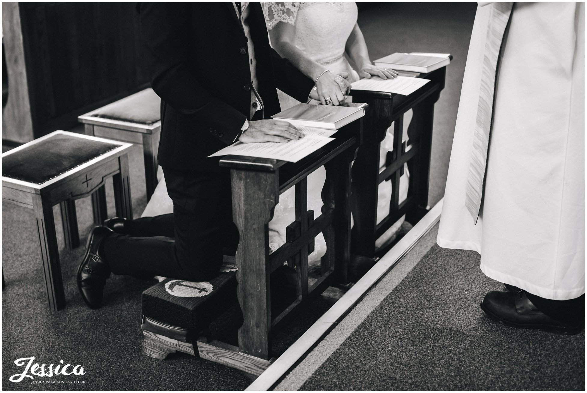 bride & groom hold hands during their wedding ceremony